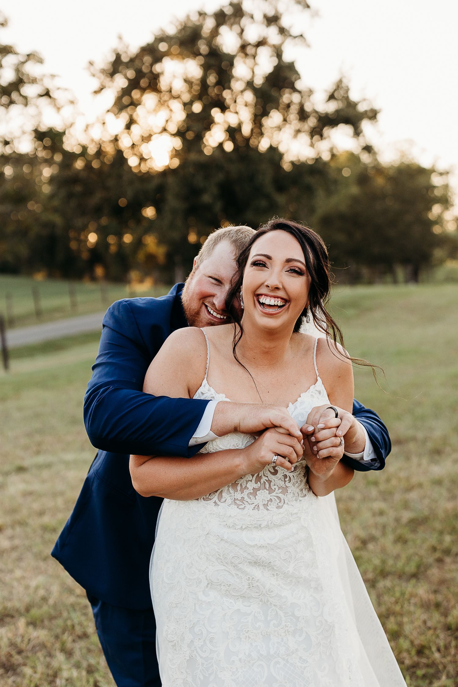 Candid moment of couple laughing together during sunset wedding photos.