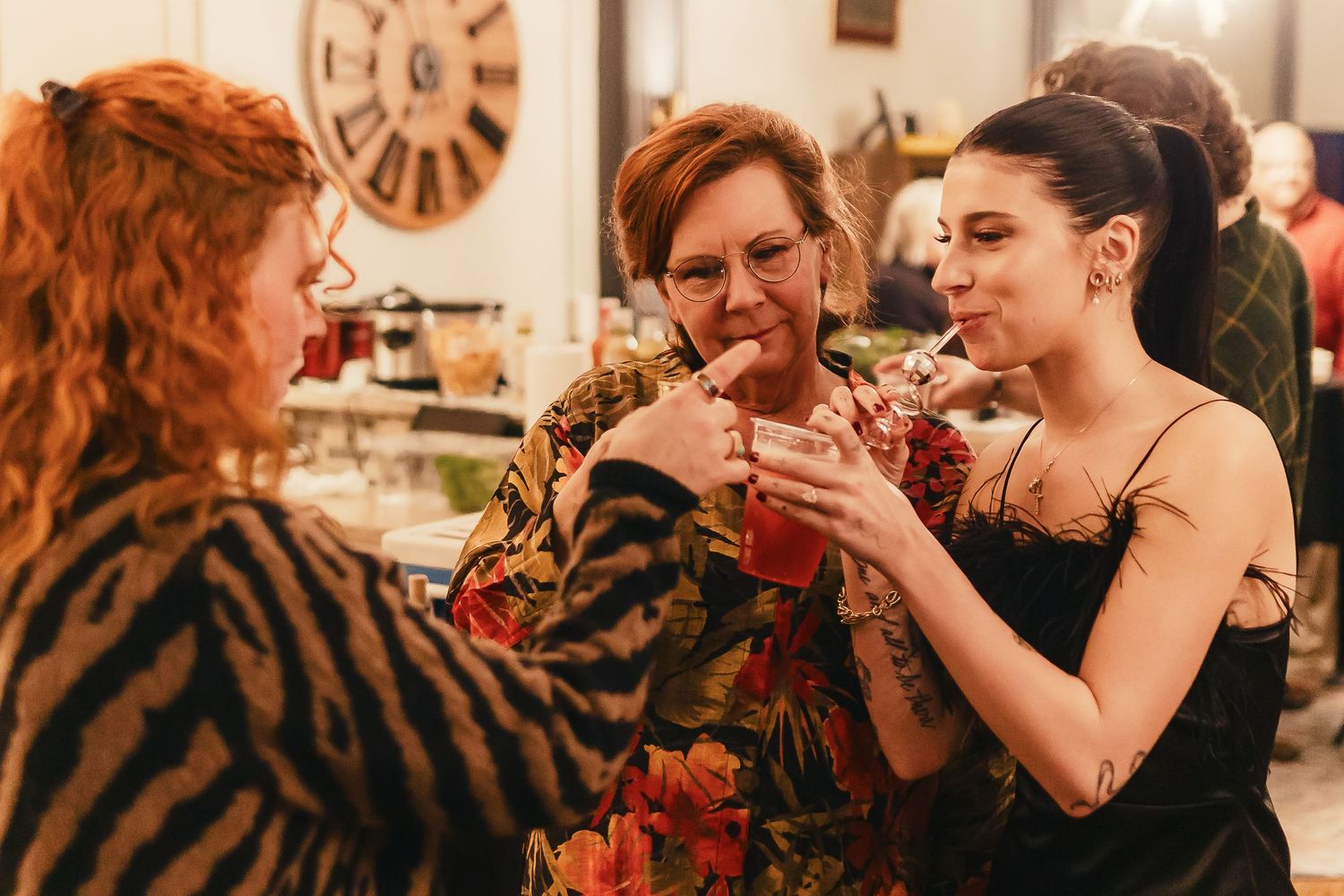 A sequence of candid moments showing people interacting and laughing together in a warm-toned indoor setting.
