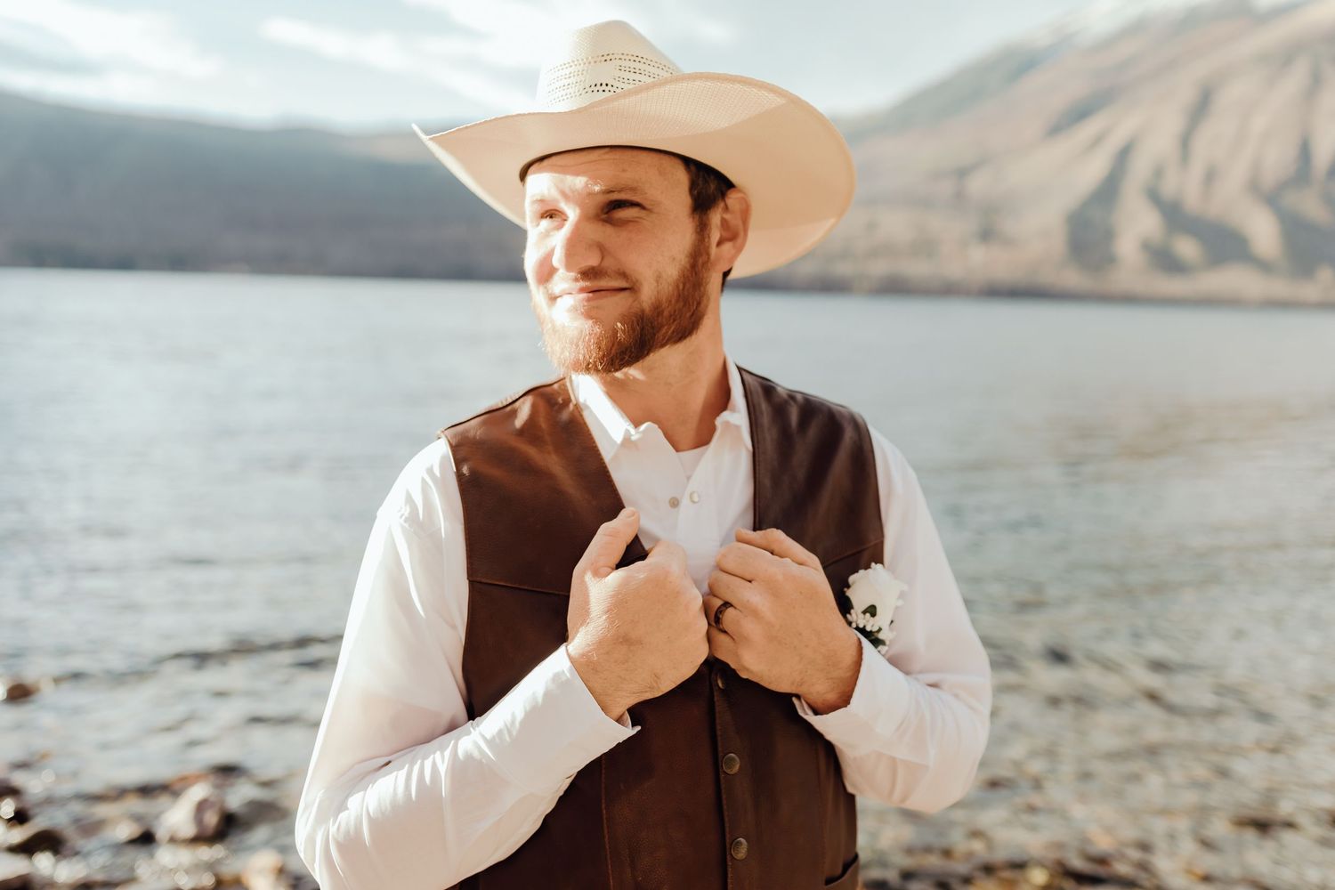 A western-themed wedding photoshoot by a scenic mountain lake.