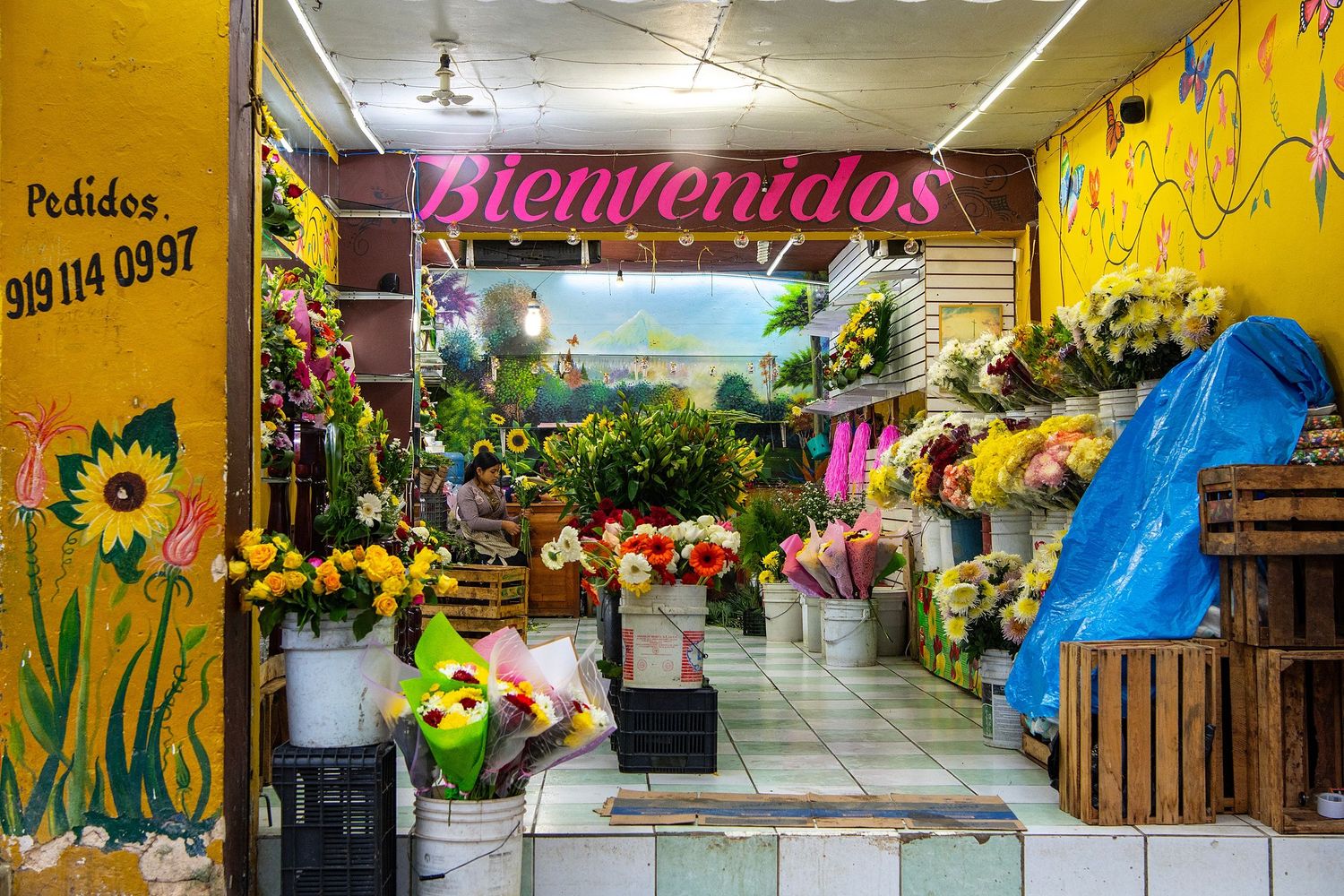 Yellow hallway with colorful decorations and a welcome sign reading 'Bienvenidos'.
