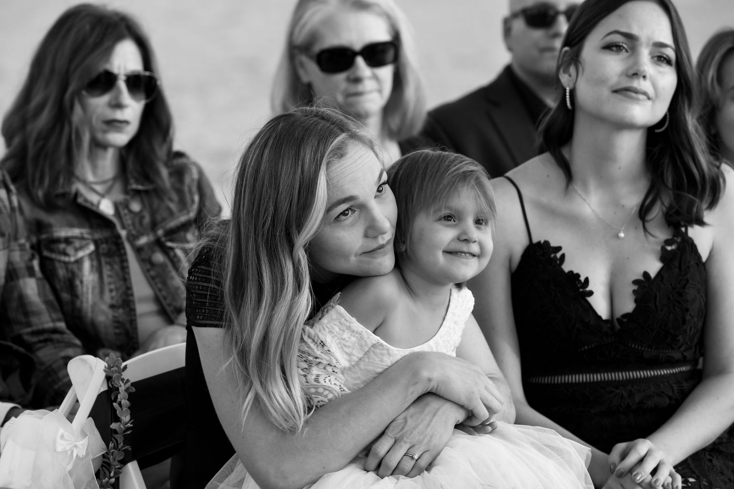 Wedding party group wearing sunglasses in casual black and white portrait.