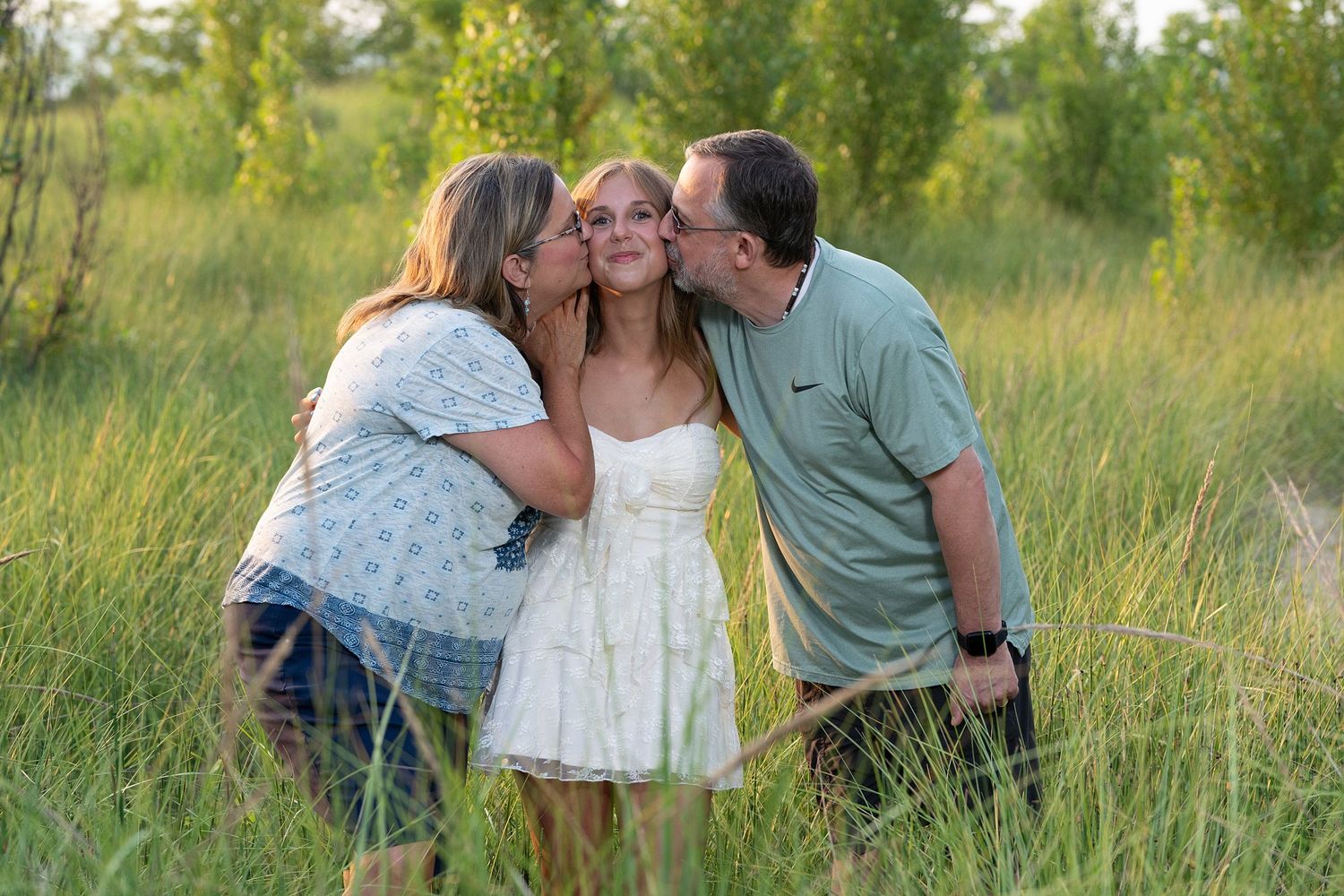Candid family moments captured in a sunny field during golden hour.