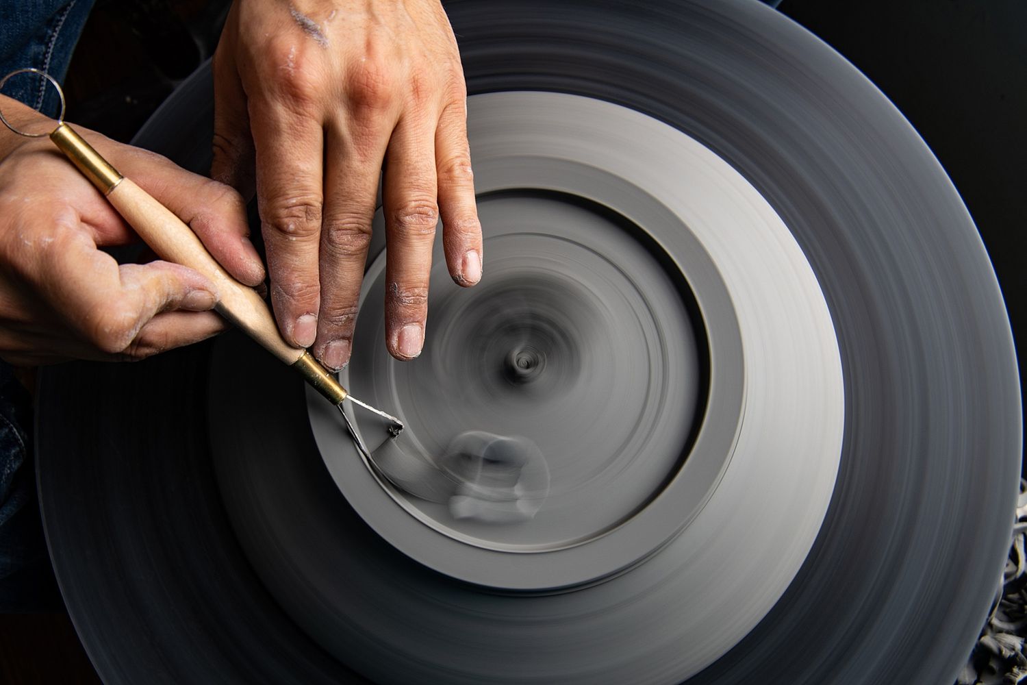 Close-up sequence showing hands manipulating a spinning vinyl record on a turntable.