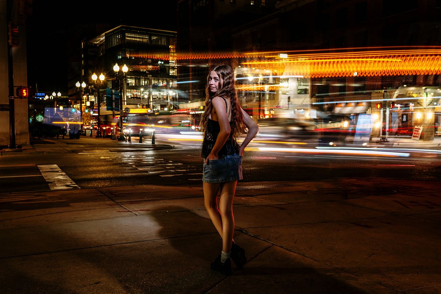 Urban nighttime street scene with blurred lights and motion trails.