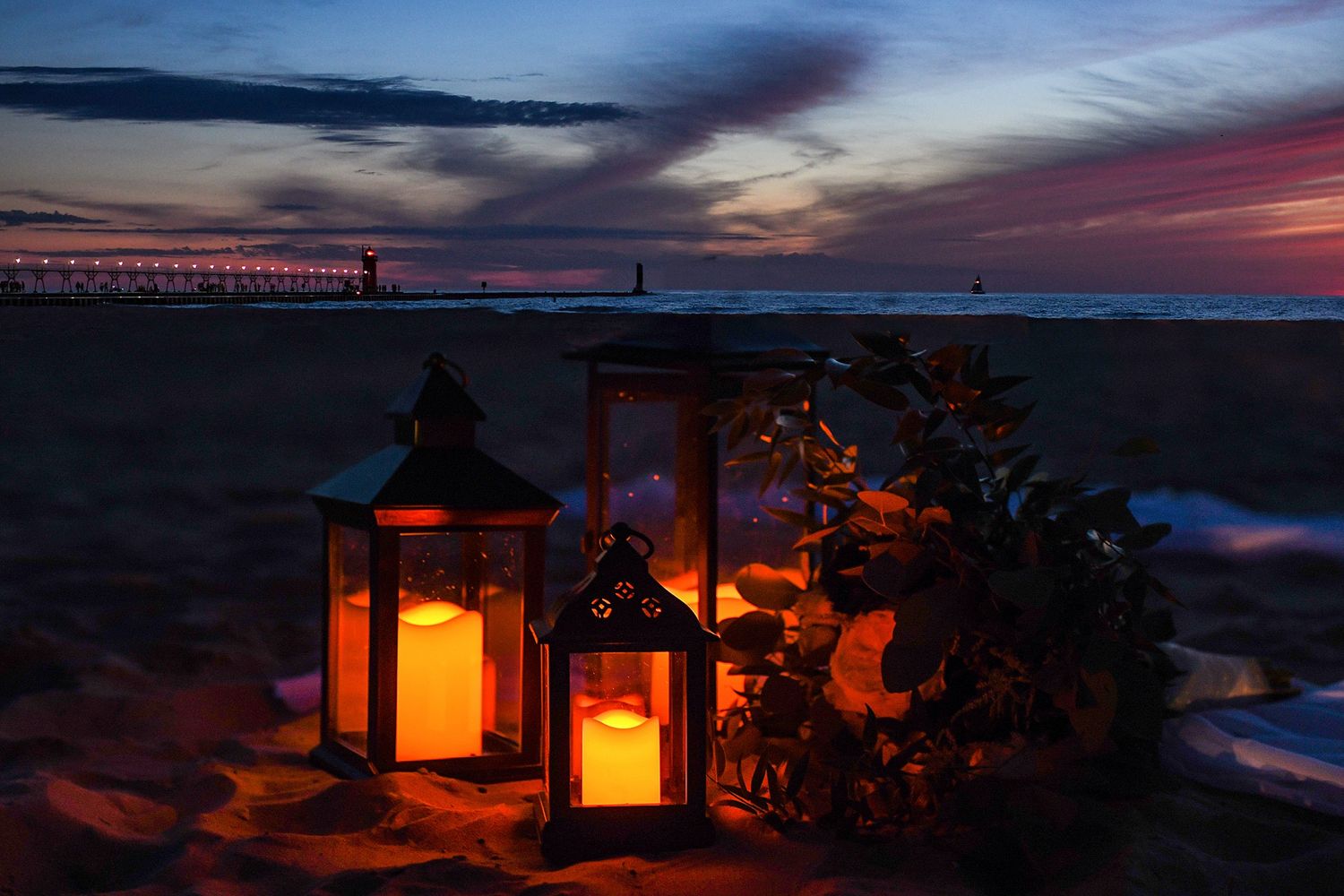 Dramatic sunset sky with glowing lanterns and silhouetted trees against colorful clouds.