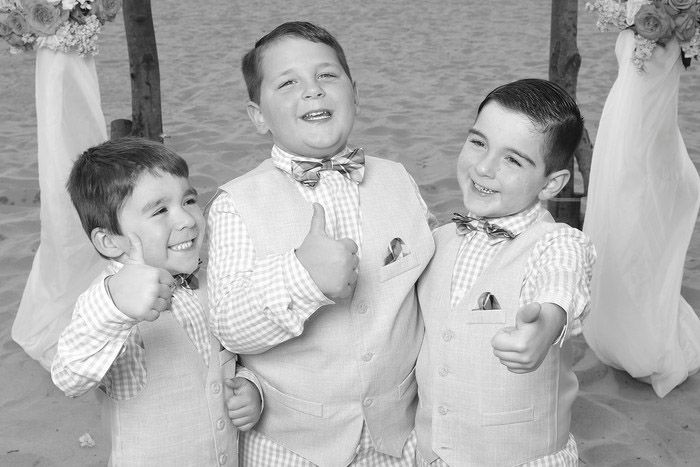 Vintage black and white photograph of three young boys in matching formal attire.
