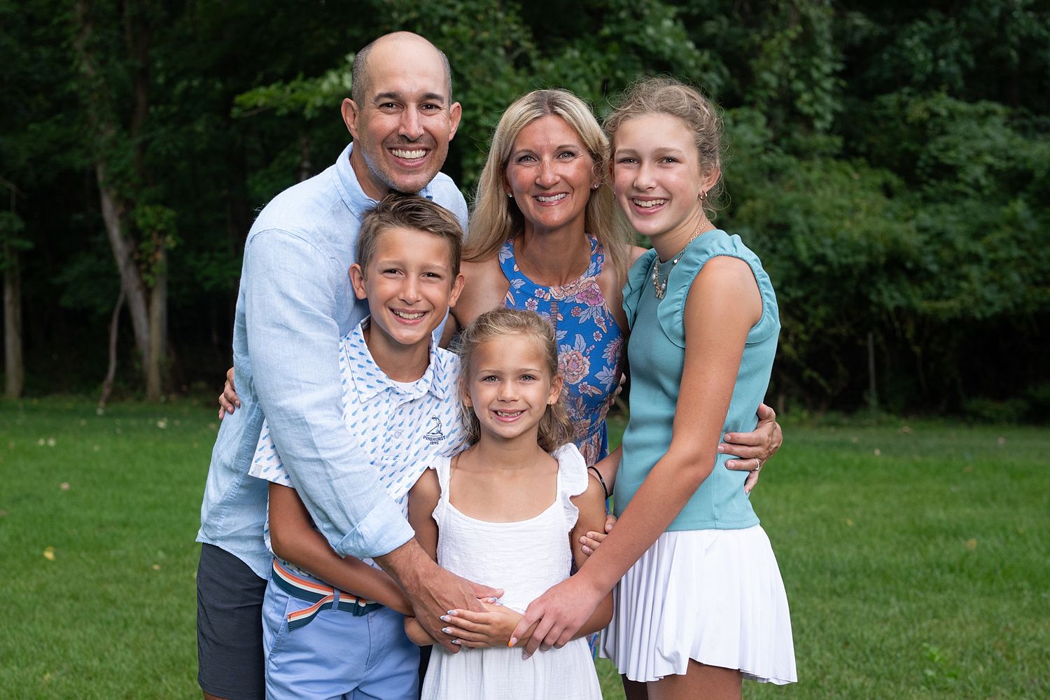 Family group photos taken in a lush green park setting during summer.