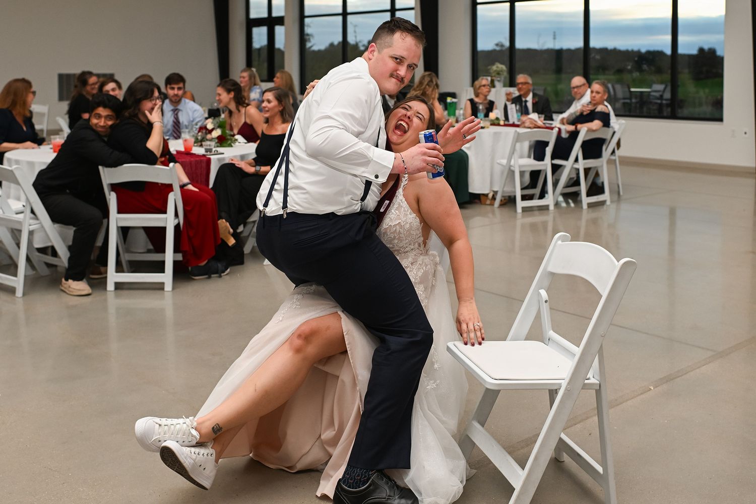 Bride and groom share a fun dip dance move at their wedding reception.