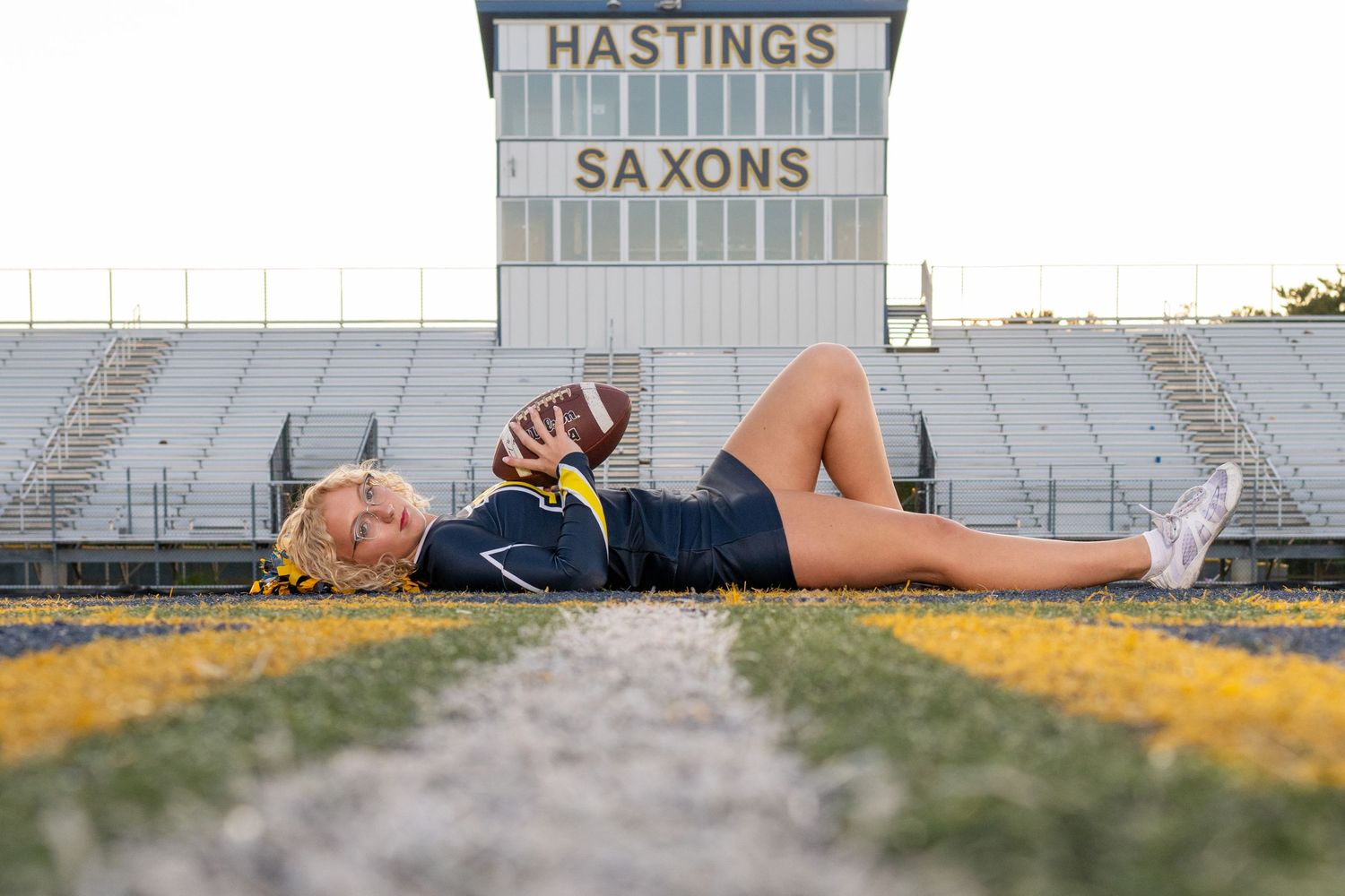 Bleacher seating at a sports stadium with 'Hastings' and 'Saxons' text visible.