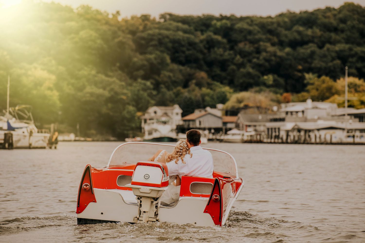 Sunset beach scene with red chairs and coastal buildings visible in the golden hour light.