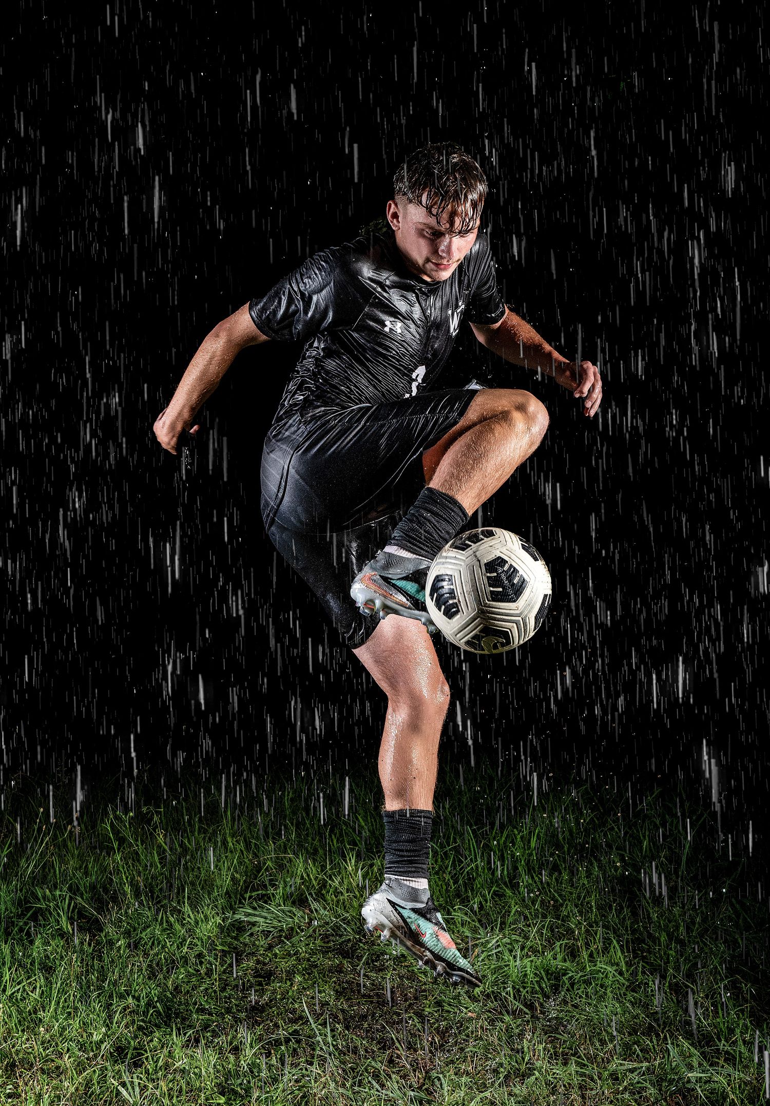 Dynamic soccer moves demonstrated on wet grass during nighttime practice.