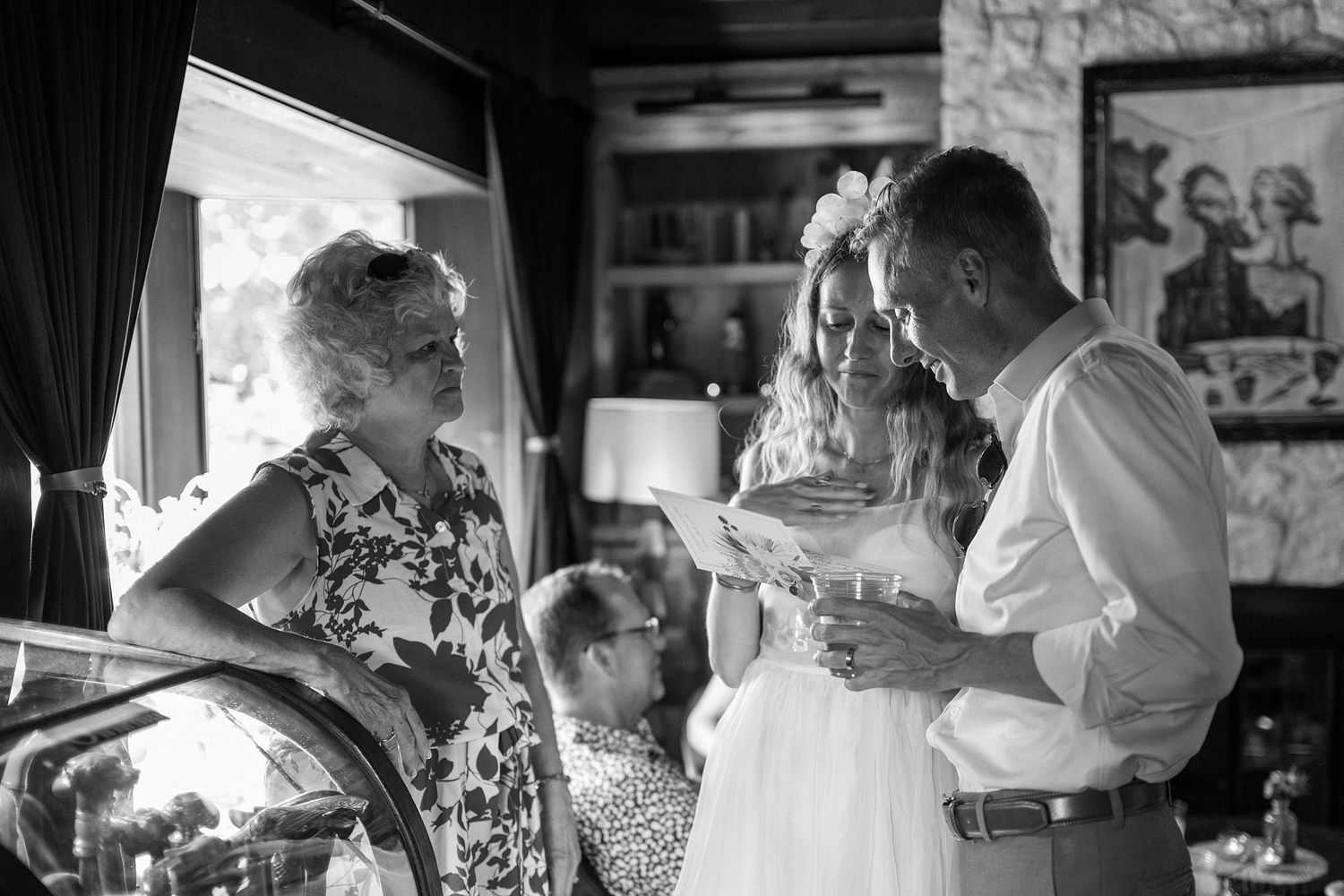 An intimate black and white moment captured during a wedding preparation.
