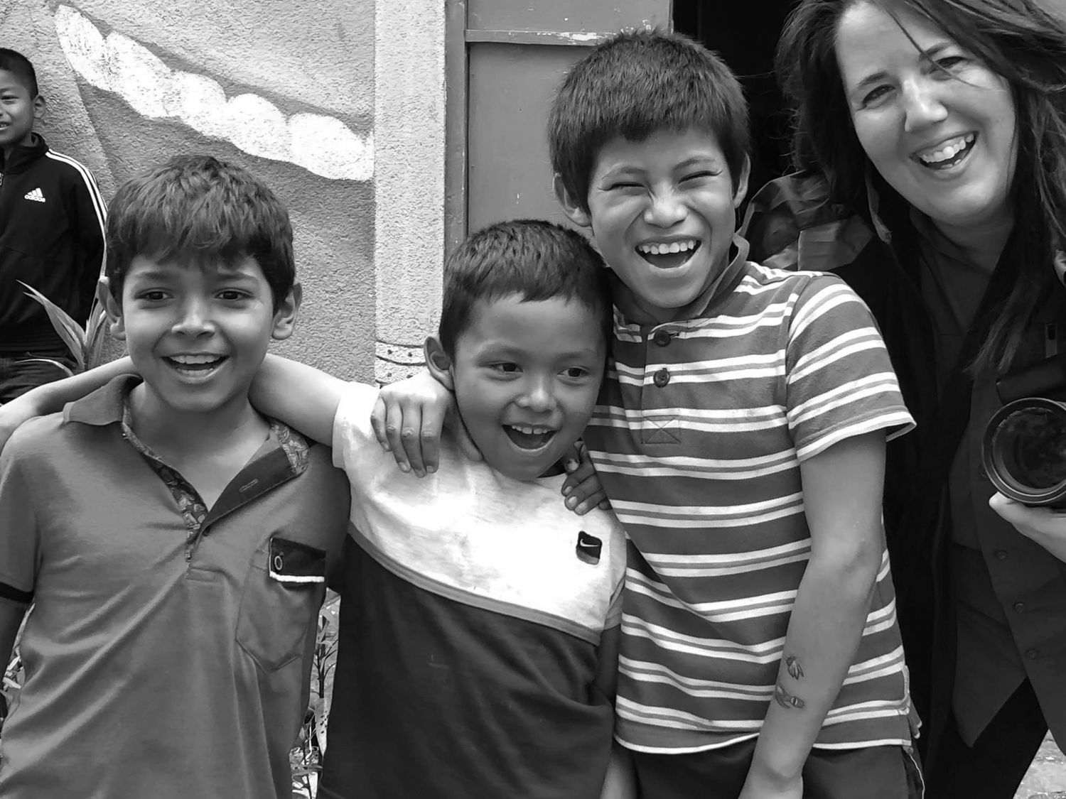A candid black and white group photo showing joyful expressions and friendship.