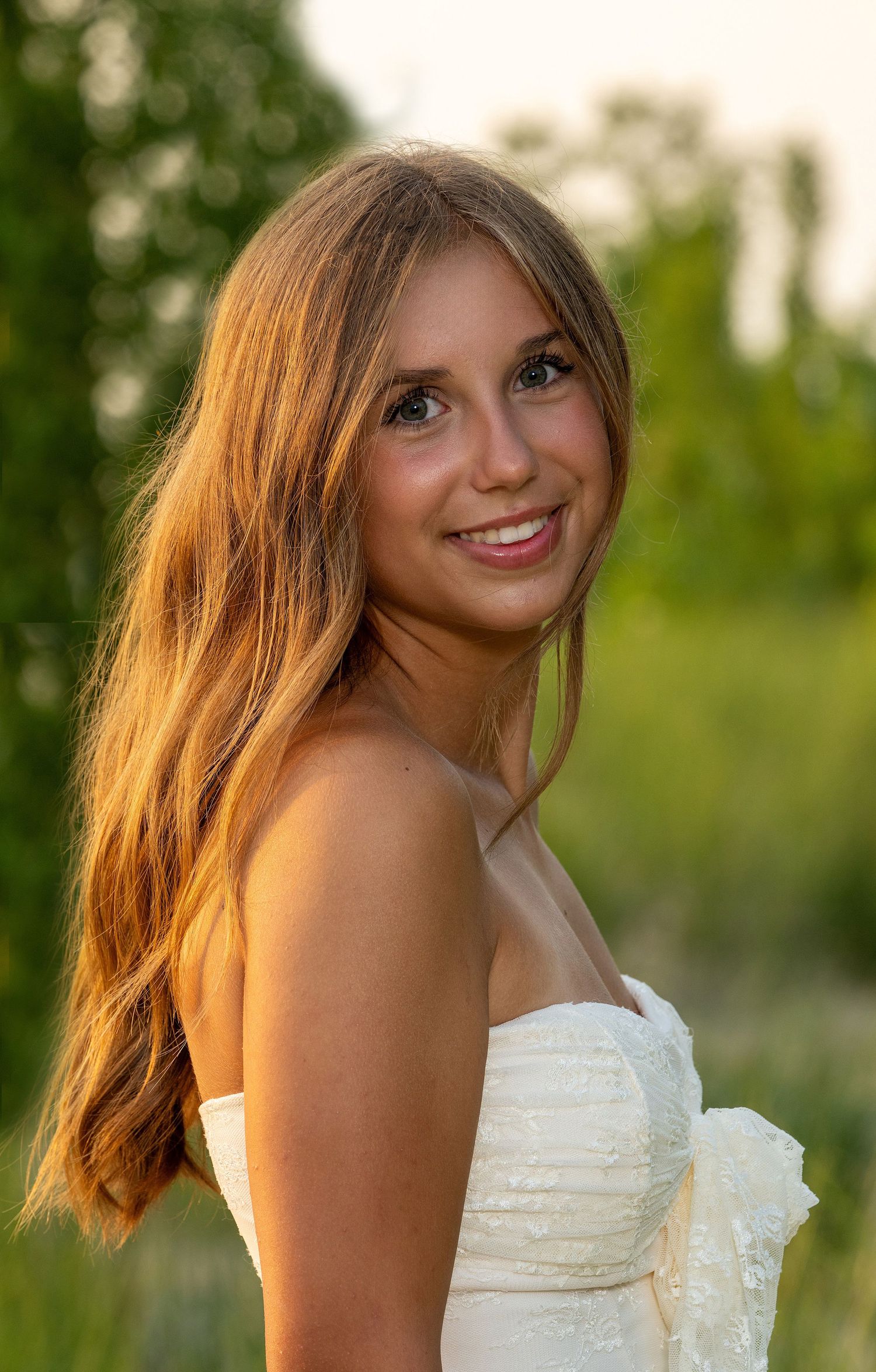 A series of outdoor portrait shots in a white dress against a natural green background.