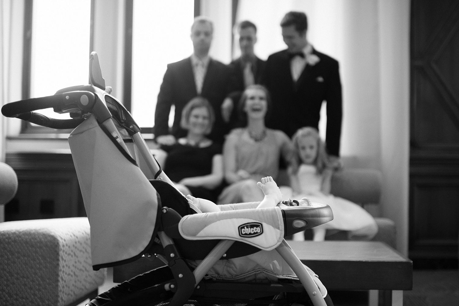 Wedding reception scene in bright interior space with guests in background.