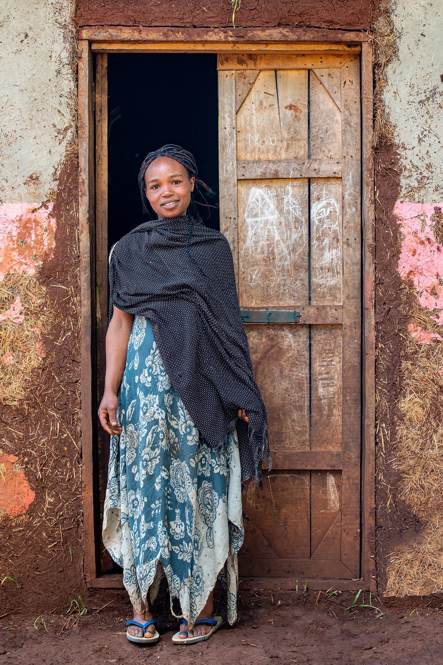 A series of photos showing a child in a blue dress peeking out from behind a wooden door.