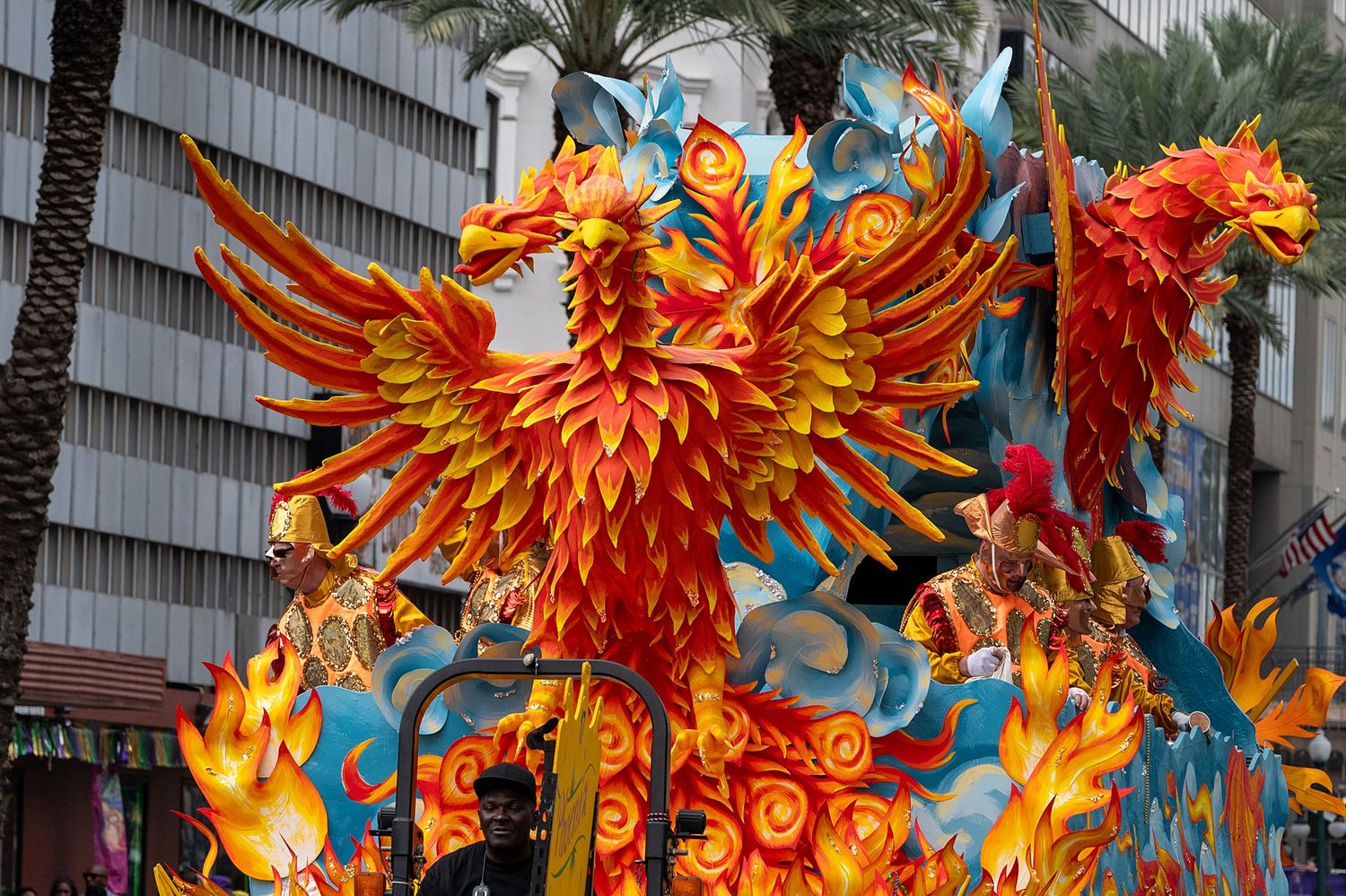 Orange and blue phoenix-themed carnival float with dramatic fiery design elements.