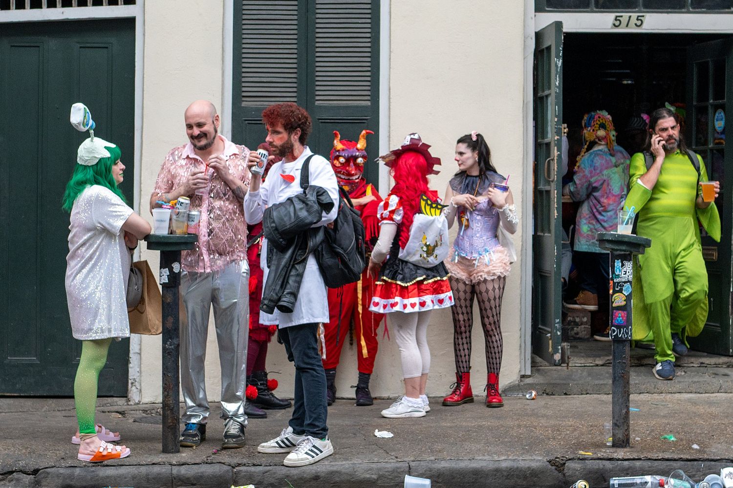 Colorfully dressed revelers celebrating on a New Orleans street corner.