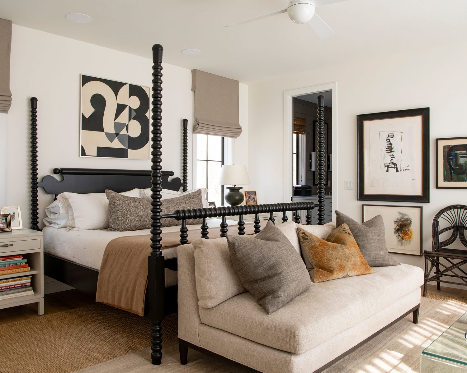 Contemporary bedroom with four-poster bed, neutral tones, and plush bedding.