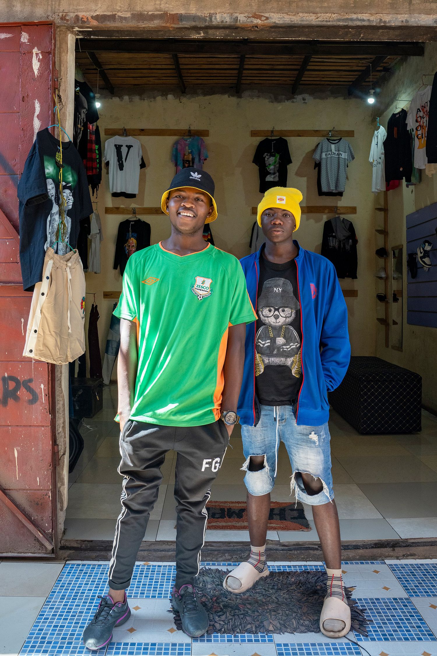 A sequence showing young people in casual clothing standing in front of a shop entrance.