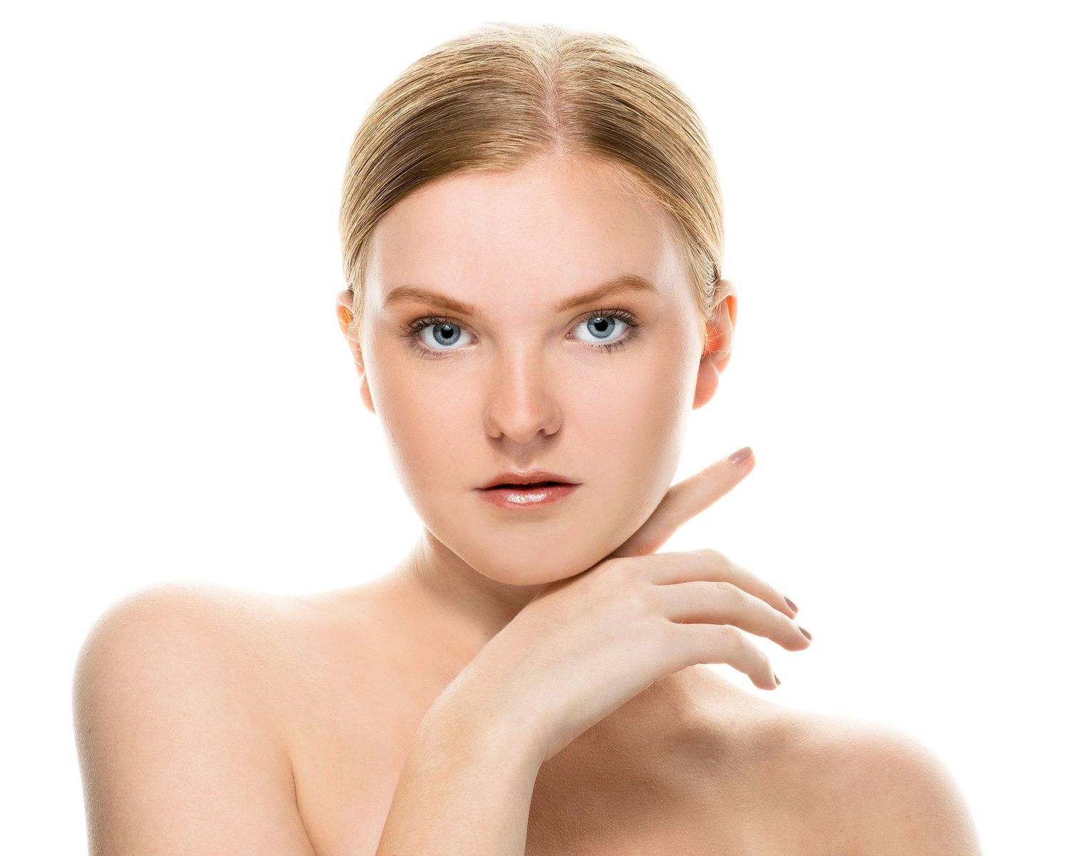 Close-up beauty shot showing clear skin and natural makeup against white background.