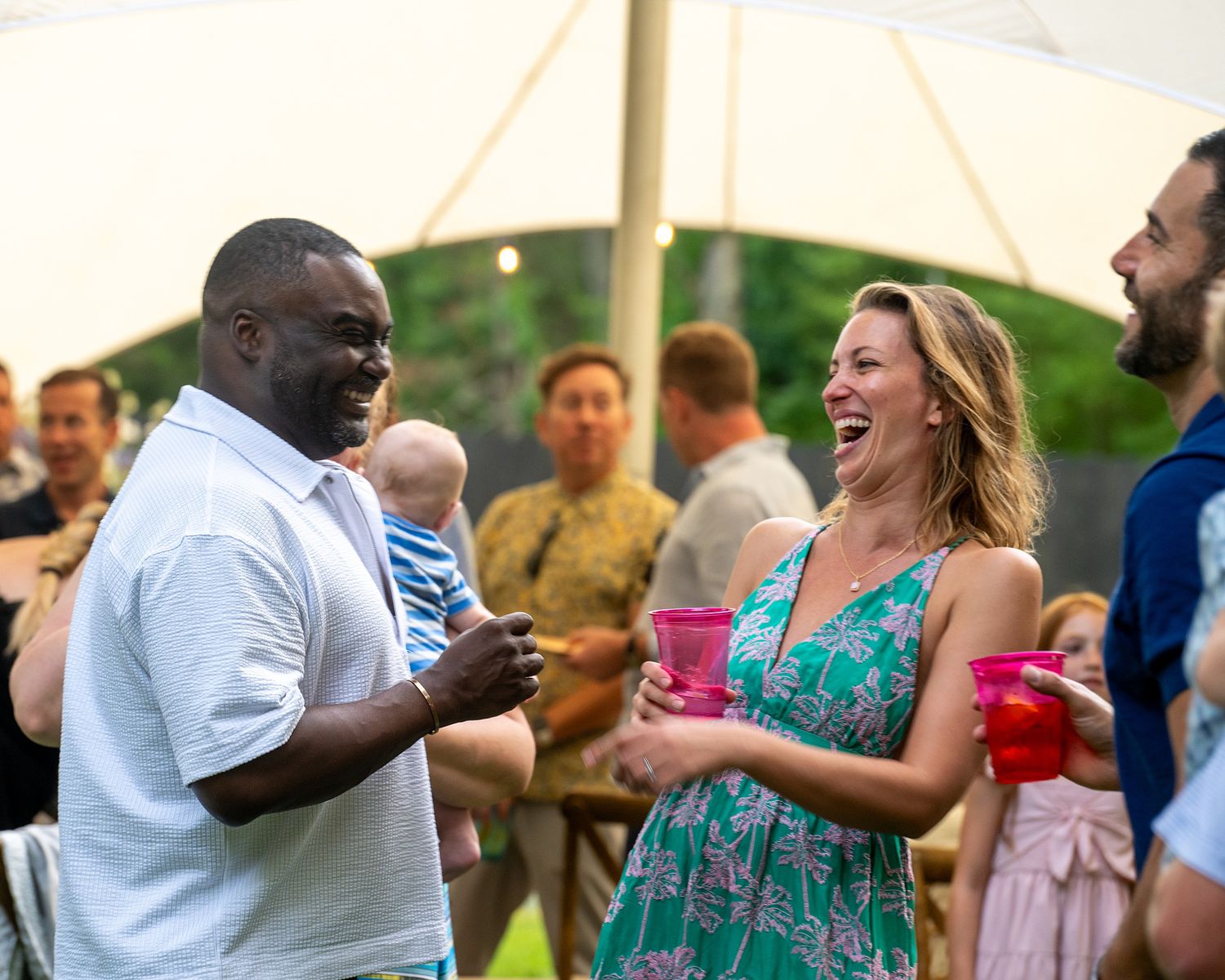 People dancing and socializing at an outdoor party or celebration event.