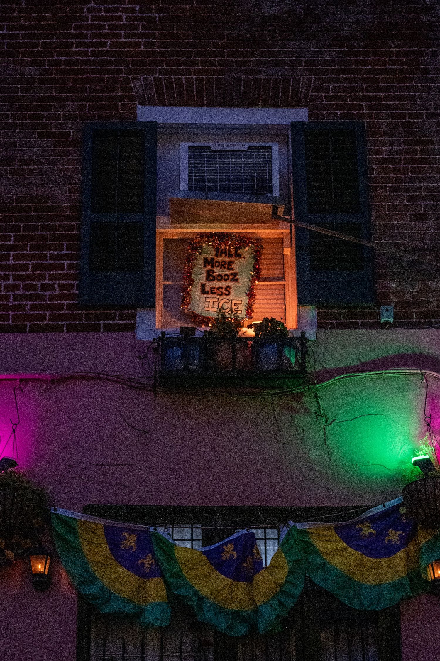 Decorated building facade with Brazilian bunting and colored lights at dusk.