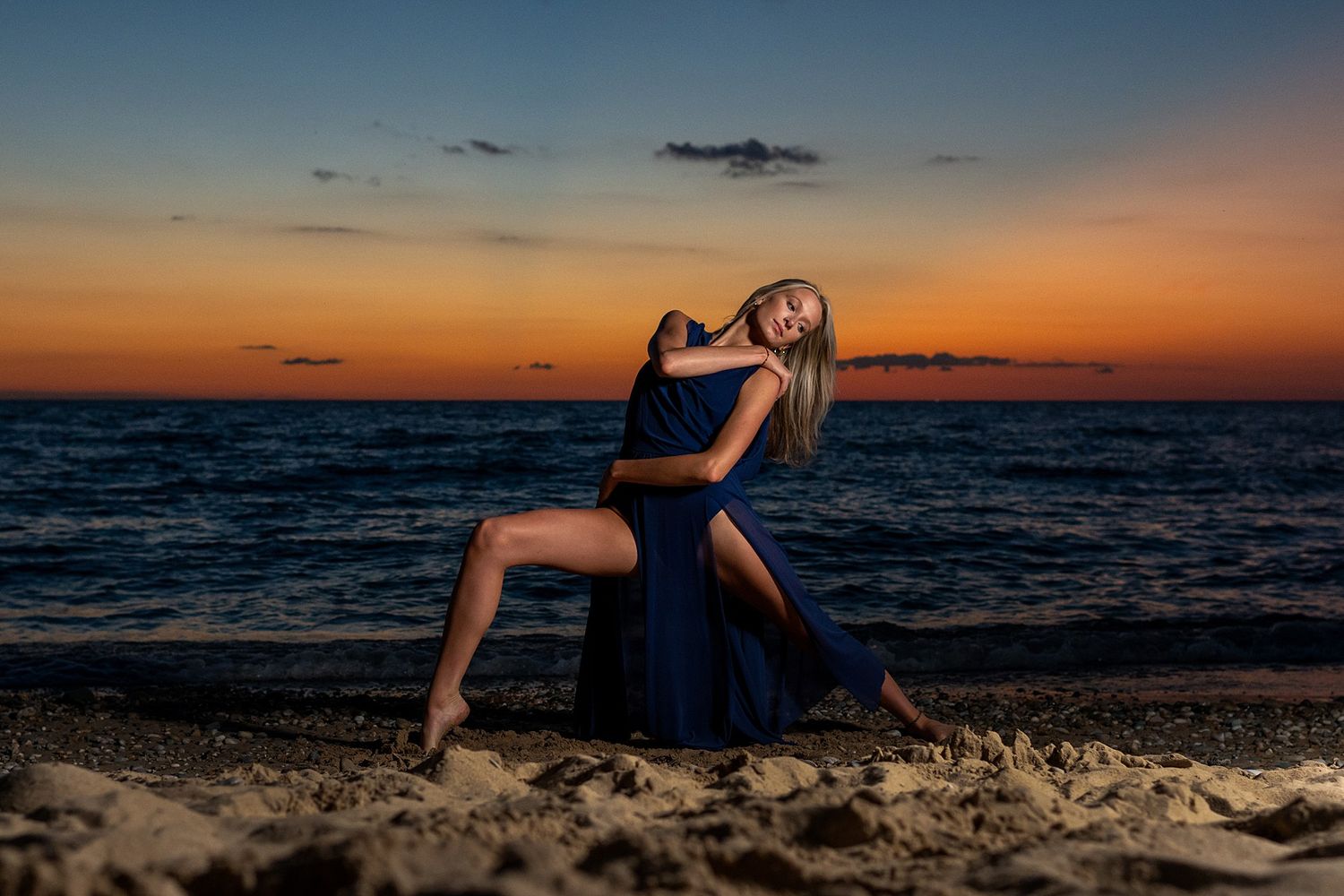 Artistic beach portraits at golden hour with flowing fabric creating dynamic movement against sunset.