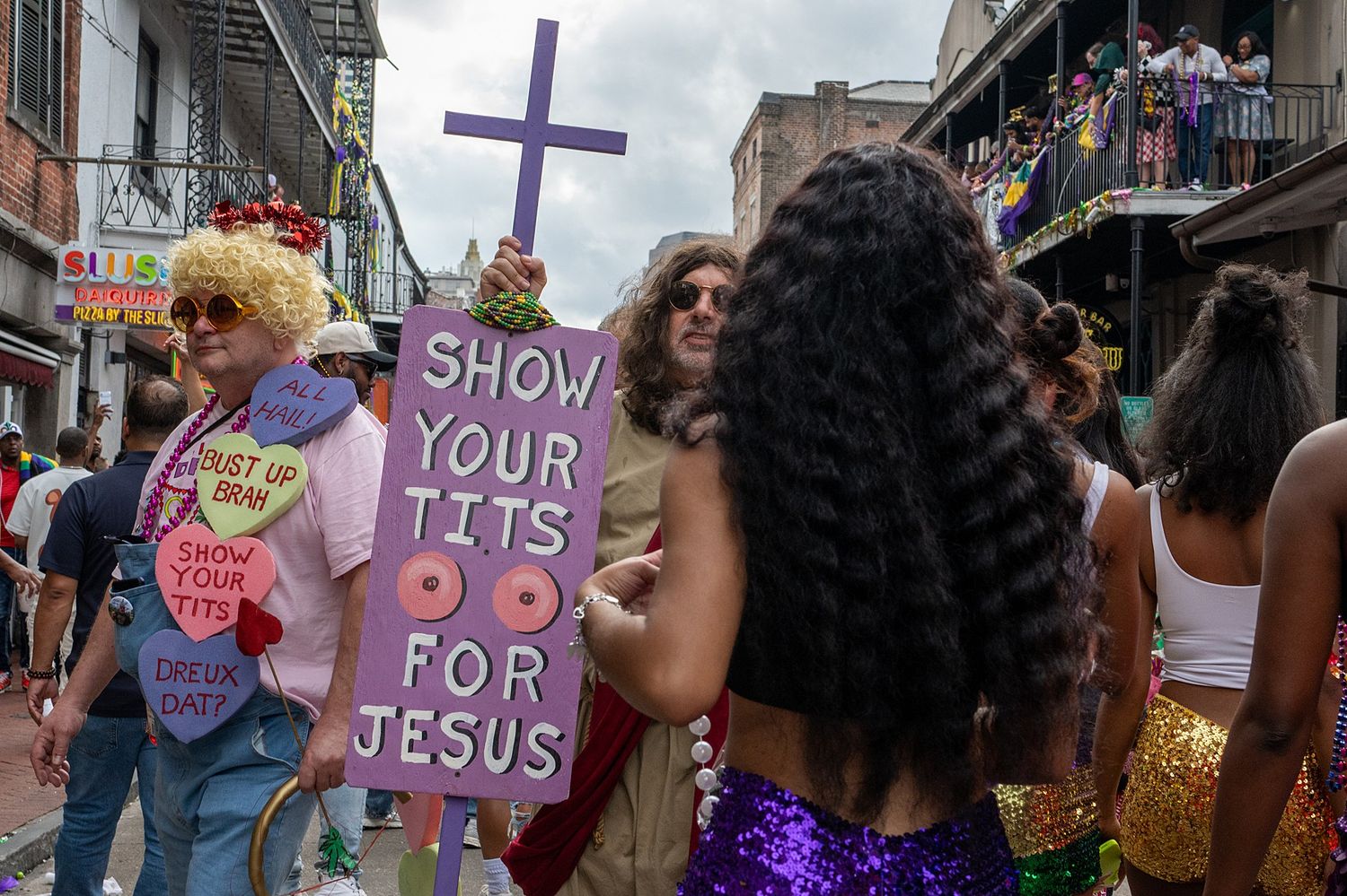 Purple signs and decorations displayed during Mardi Gras celebrations in the French Quarter.