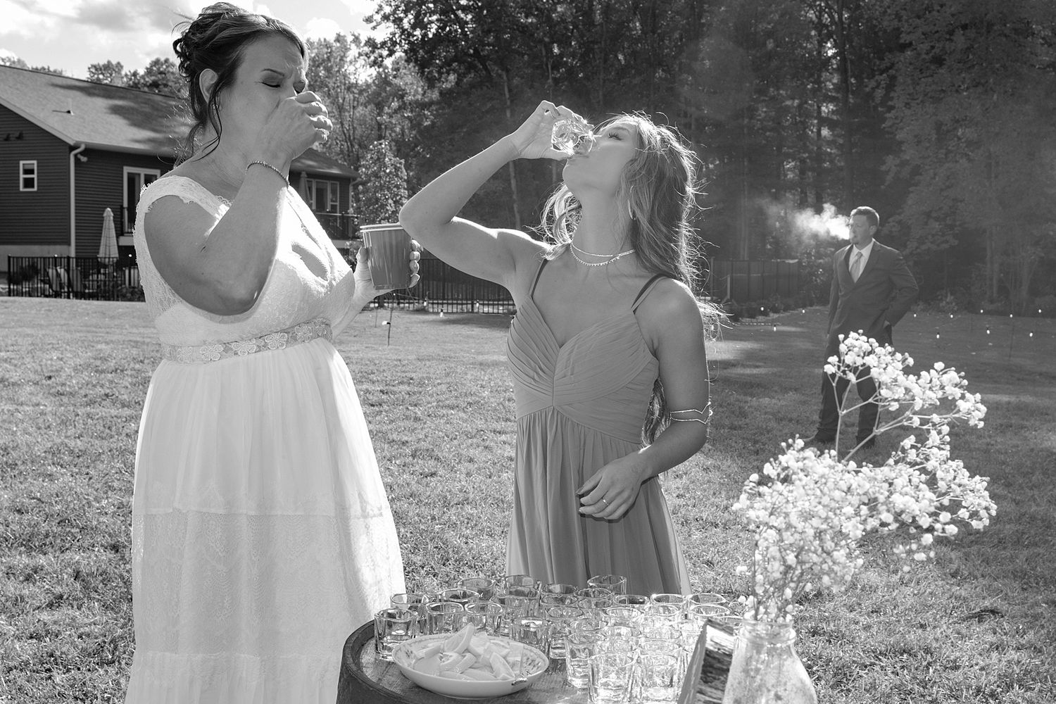 Black and white wedding party candid shots outdoors.
