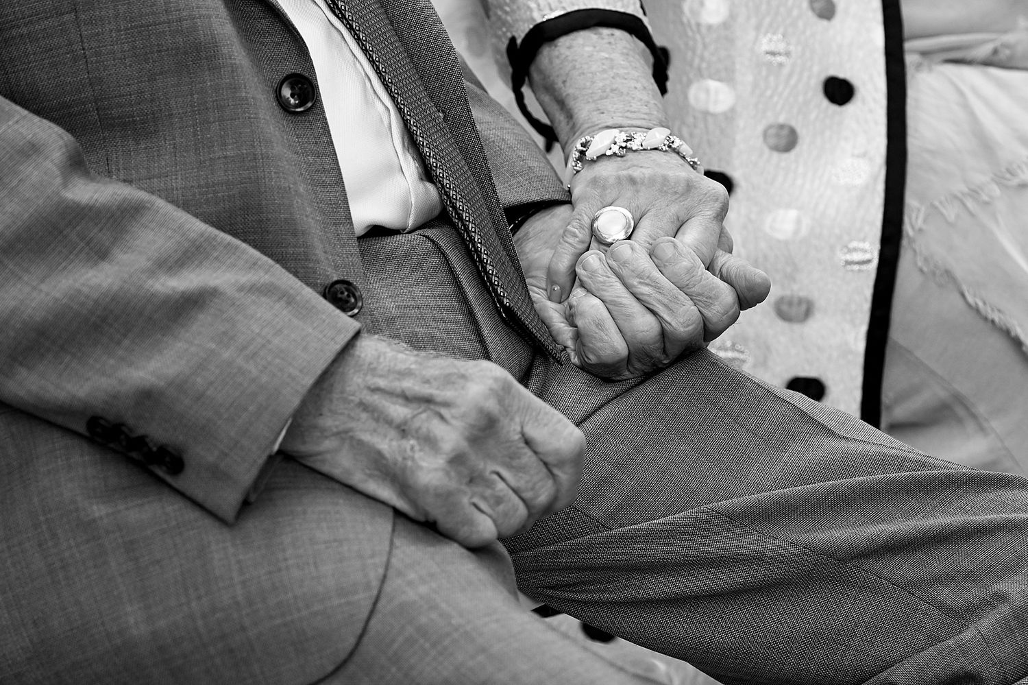 Close-up shots of hands resting on grey fabric in sequence.