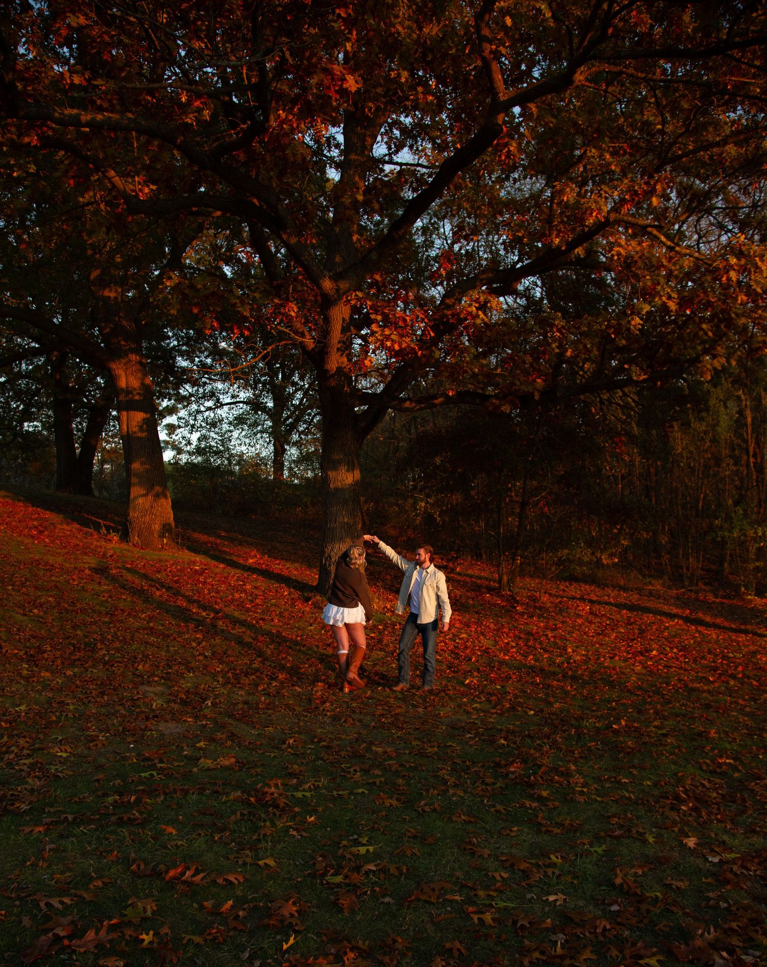 Michigan fall couples photo shoot spinning under a tree