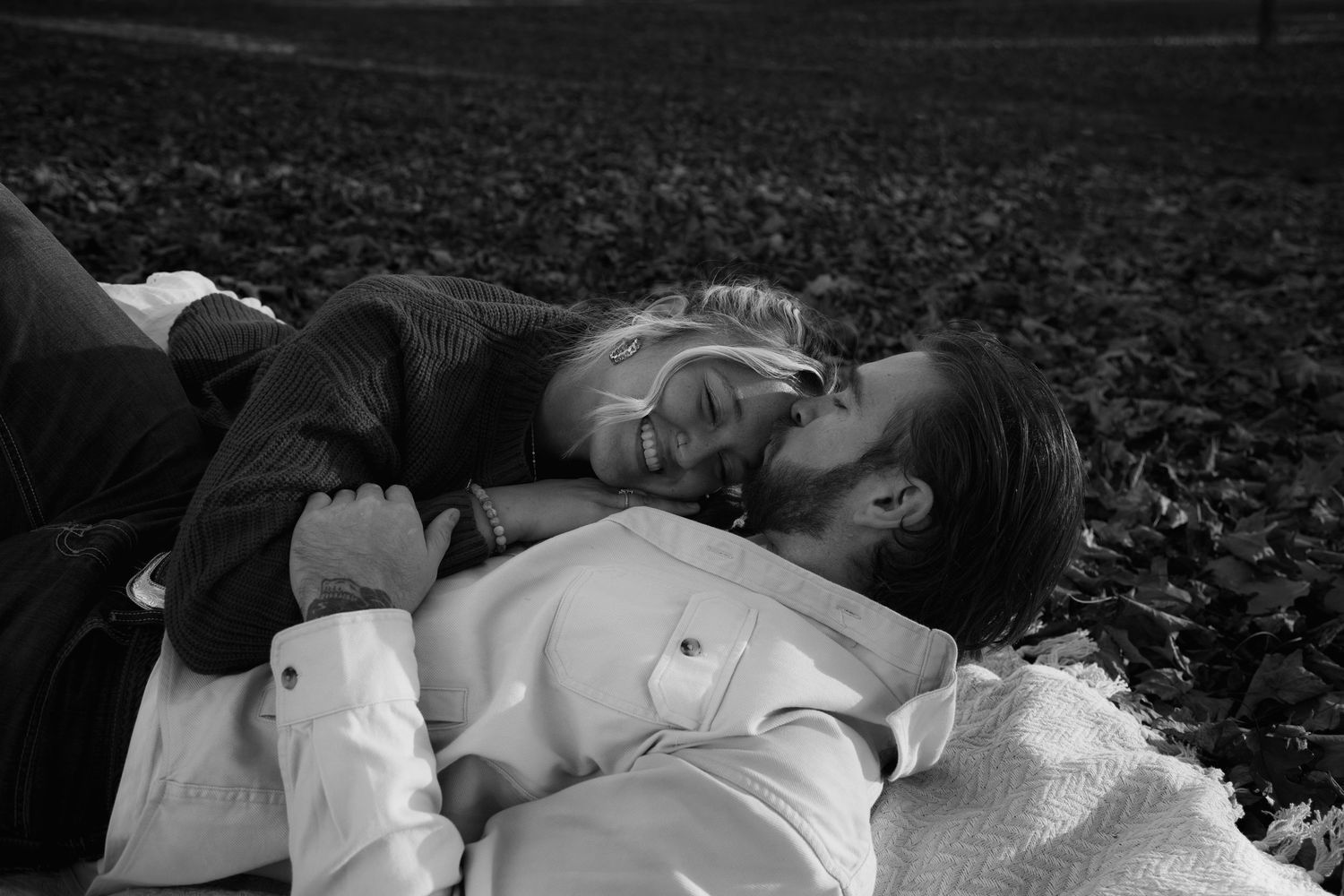 Michigan fall couples photo shoot. Cozy on a blanket picture is in black and white.
