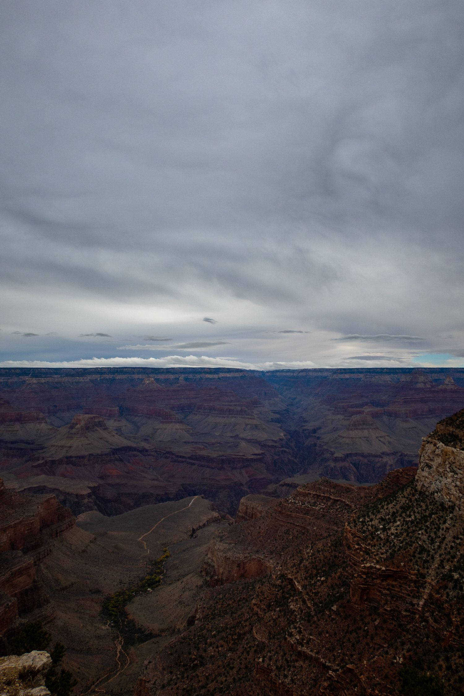 Majestic view of Grand Canyon's endless ridges and valleys beneath stormy skies.