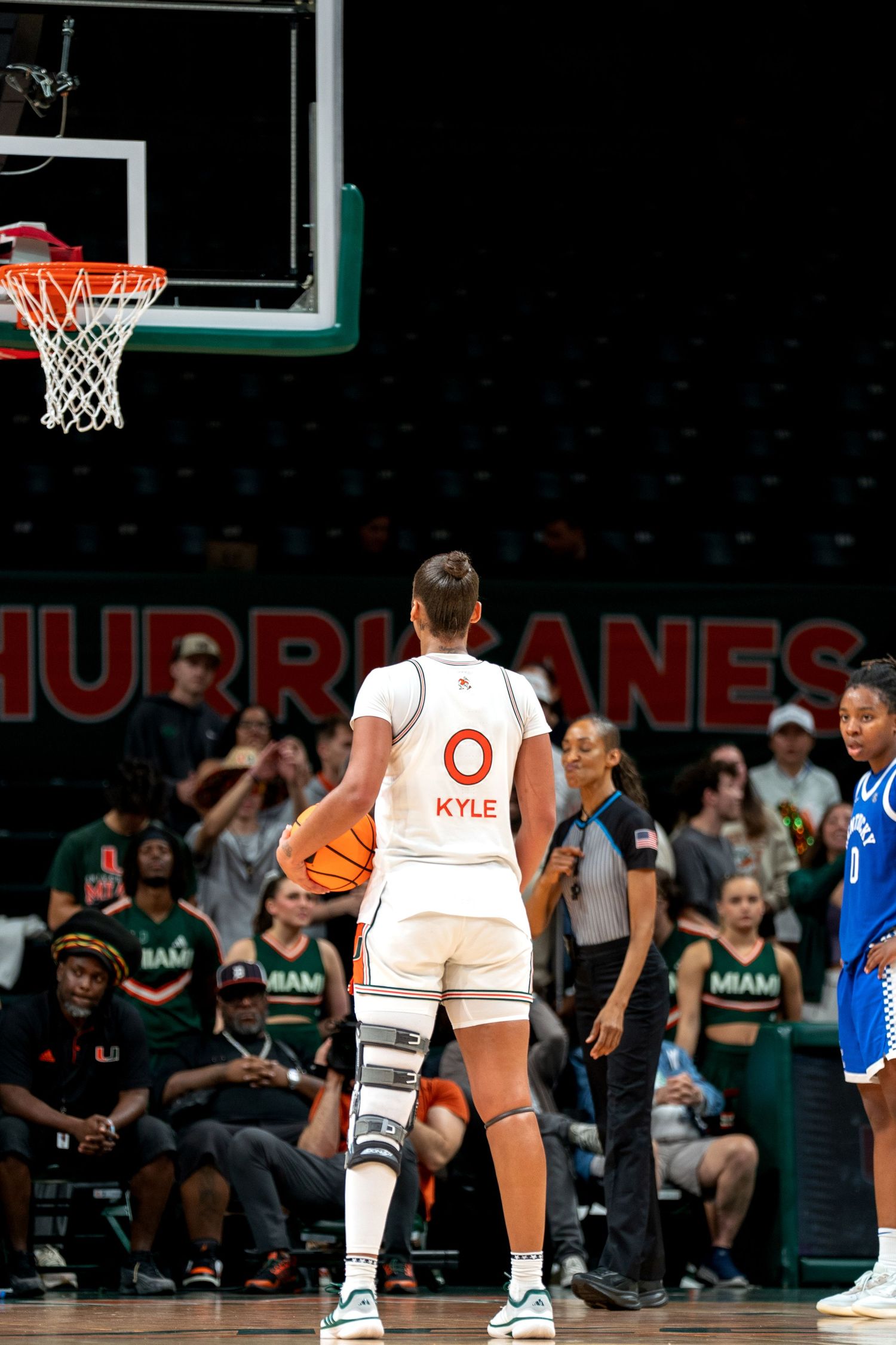 Basketball players position themselves on the court during a competitive game.