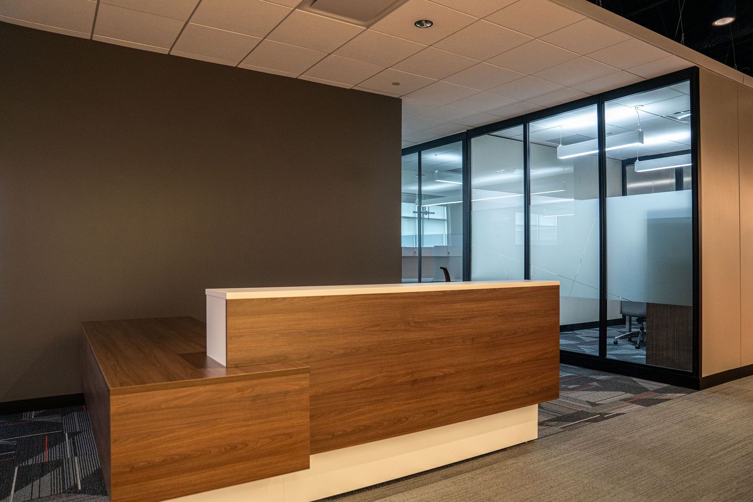 Modern office space under construction with wooden wall panels and glass partitions.