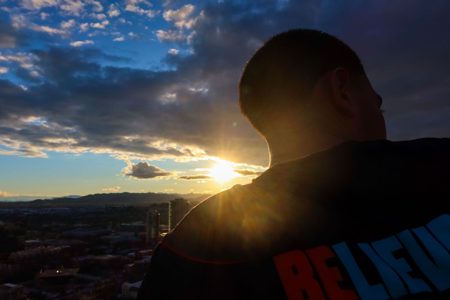 Dramatic silhouettes against blue sky and setting sun.