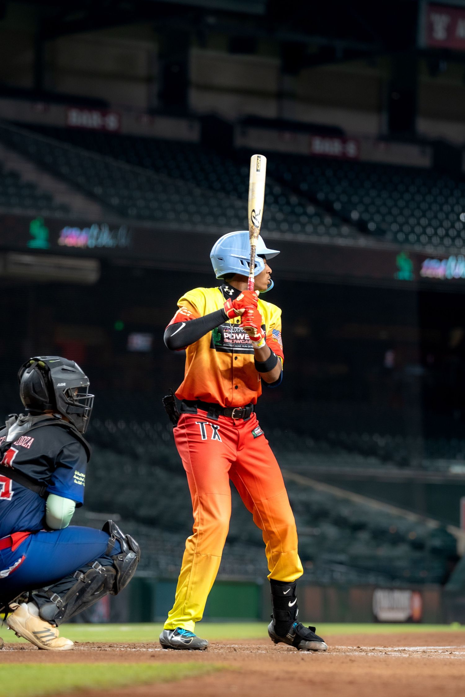 Baseball batter in orange uniform shown in sequence of four batting stance positions at home plate.