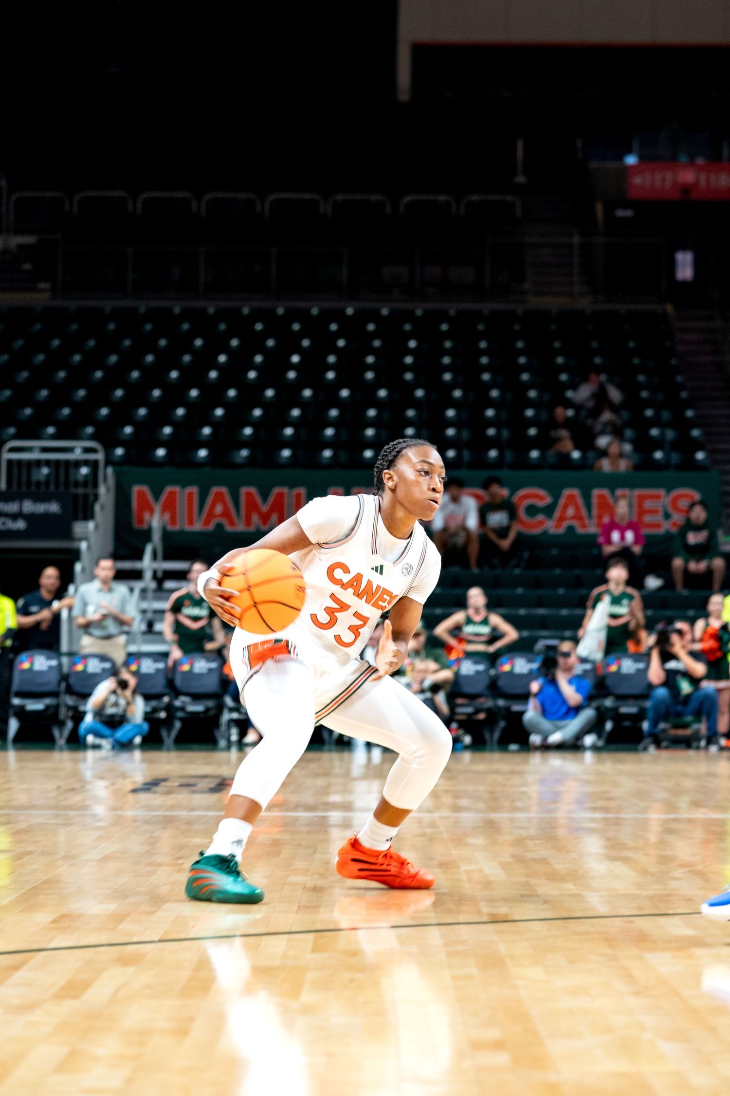 Basketball players in Miami uniforms dive for loose ball during game.
