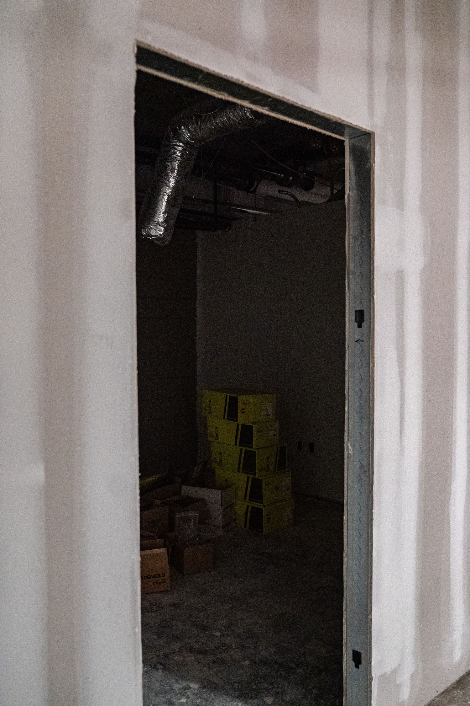 Unfinished doorways and white walls in commercial space under construction.