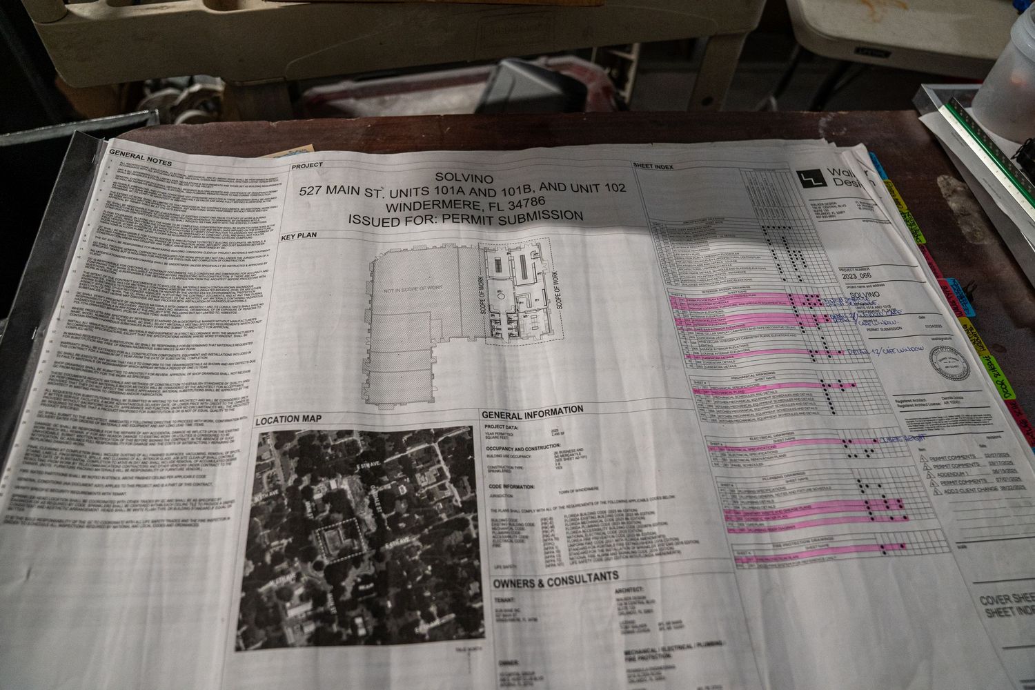 Close-up view of printed documents with highlighted text and black and white photographs.