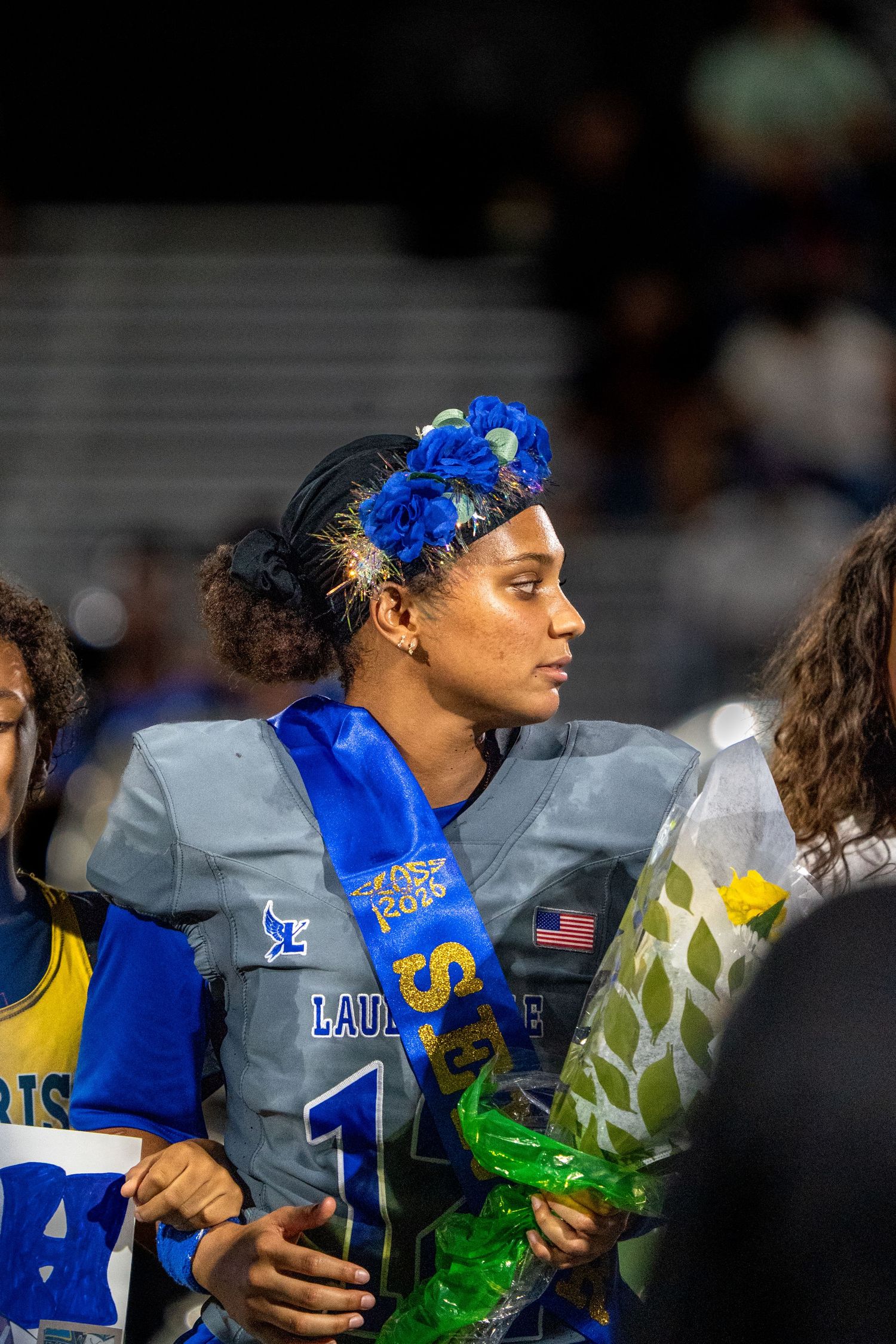 Athletes in blue and yellow uniforms standing together during a sports event.