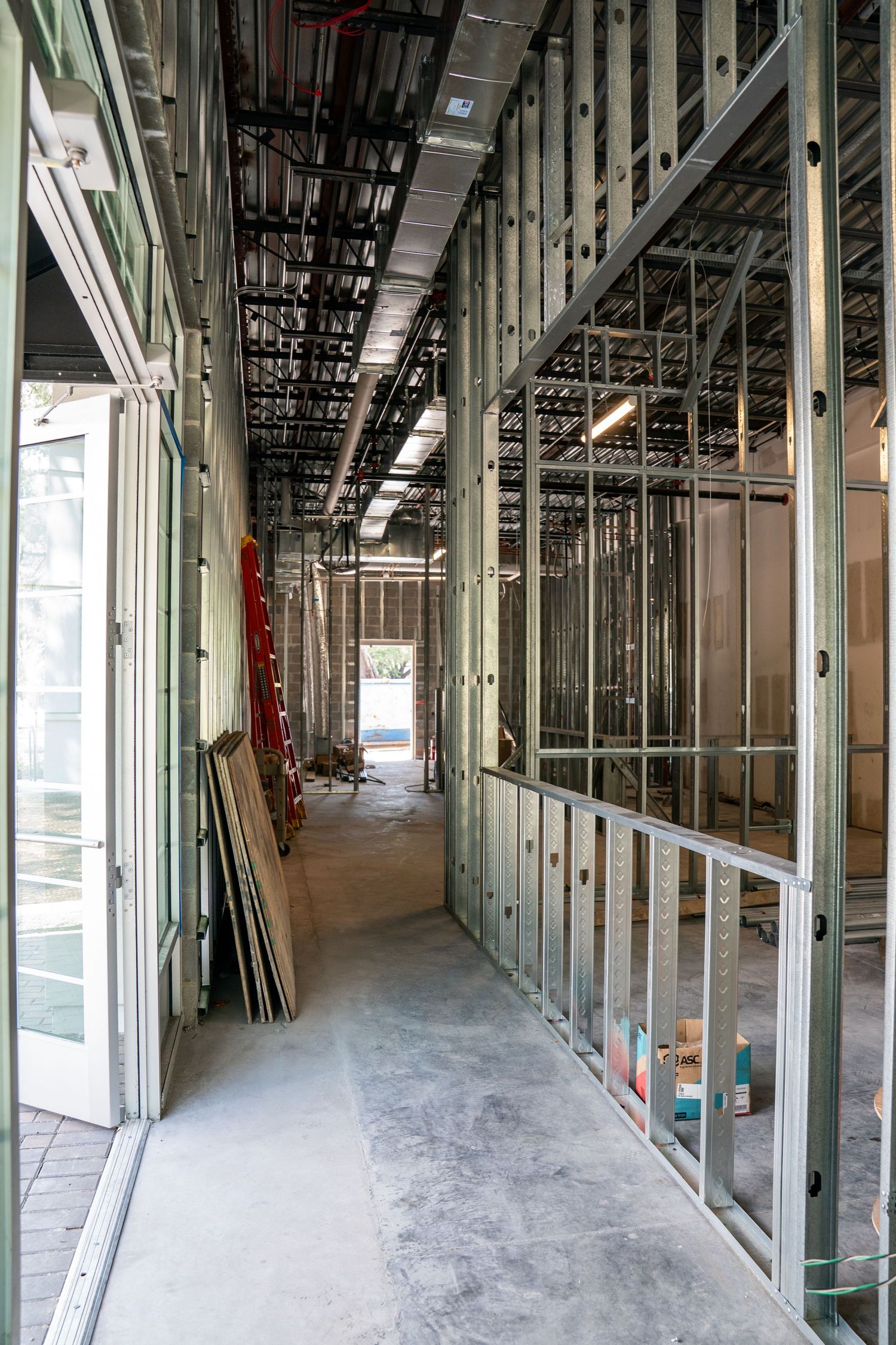 Panoramic view of commercial building interior during construction phase with metal framing.