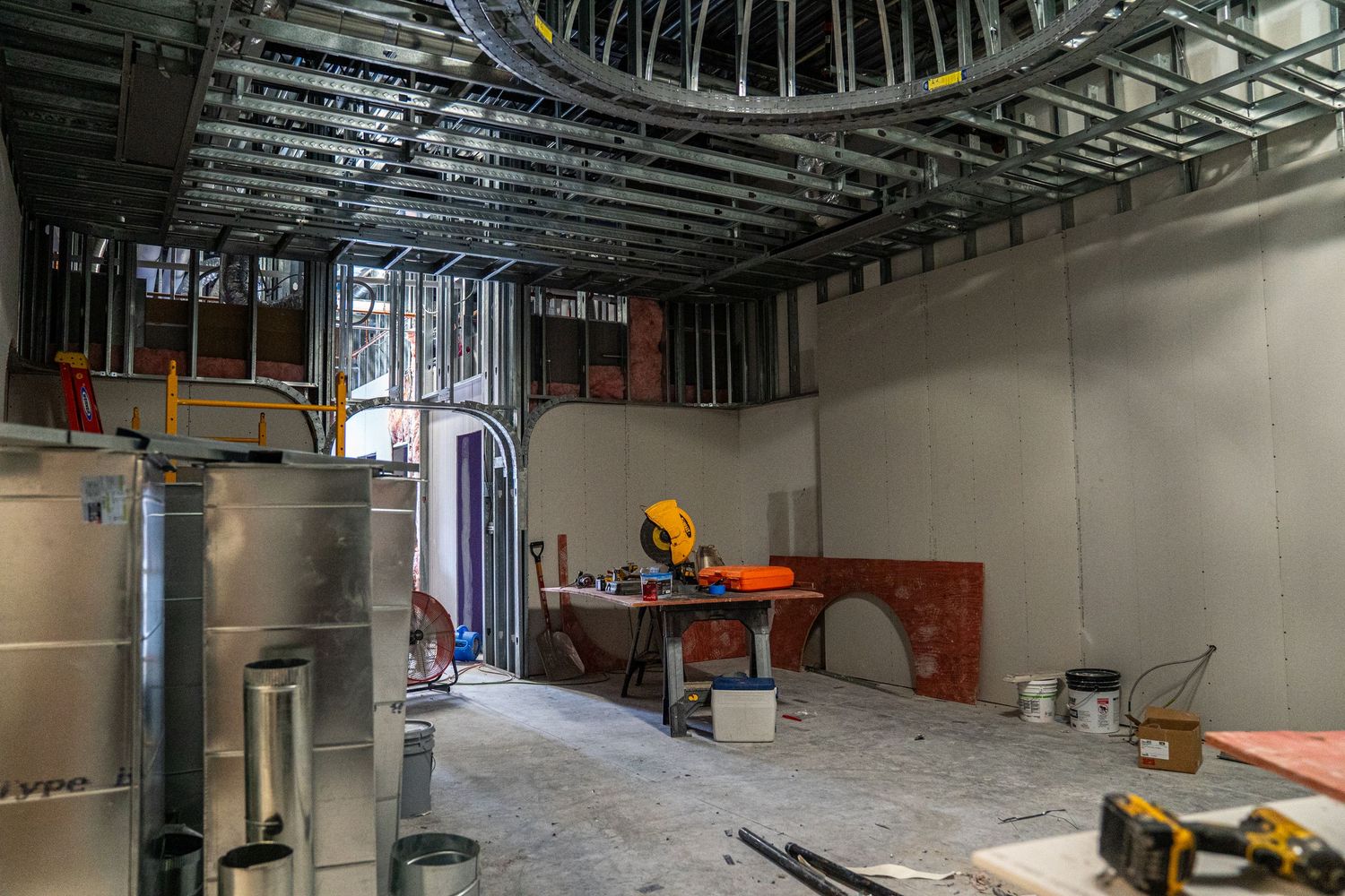 Commercial building interior showing exposed ductwork and electrical installations during renovation.