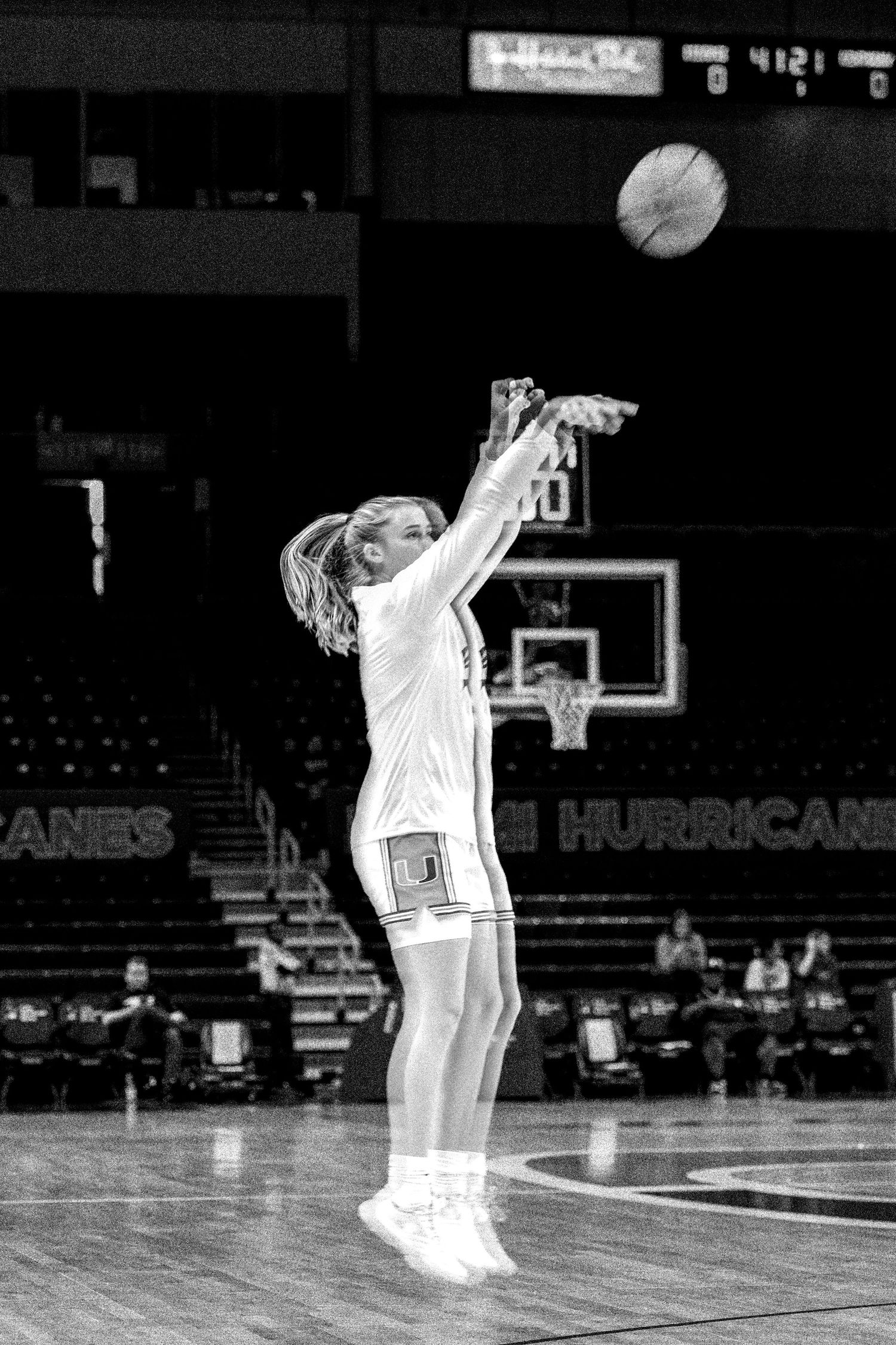 Player practices shooting form during pre-game warmups on the basketball court.