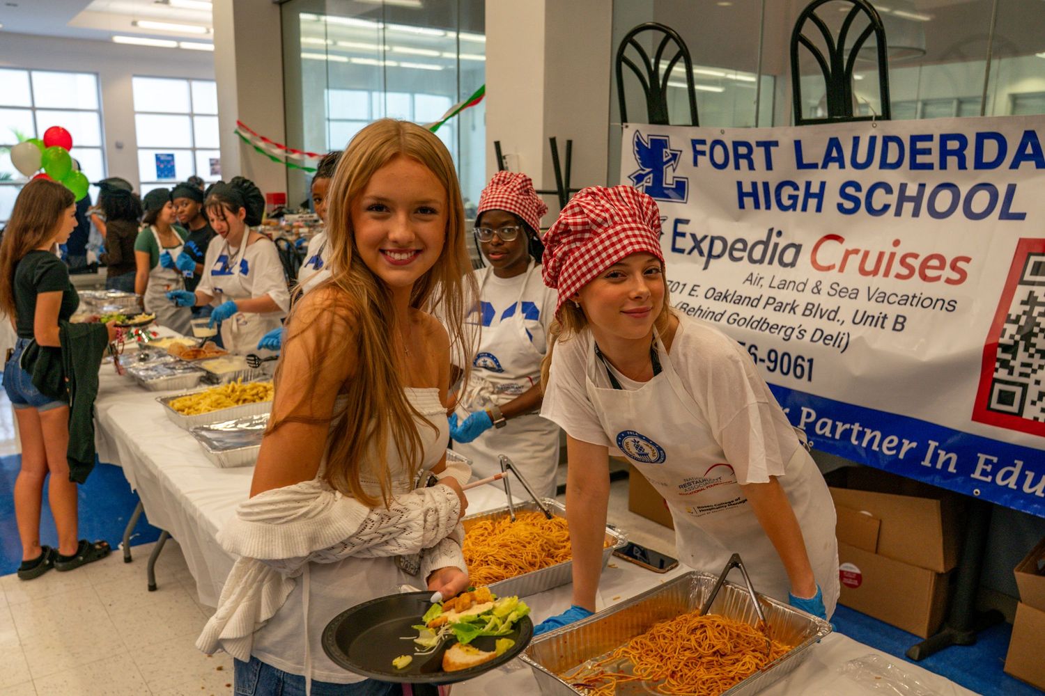 Food service preparation area with banners and serving stations set up.