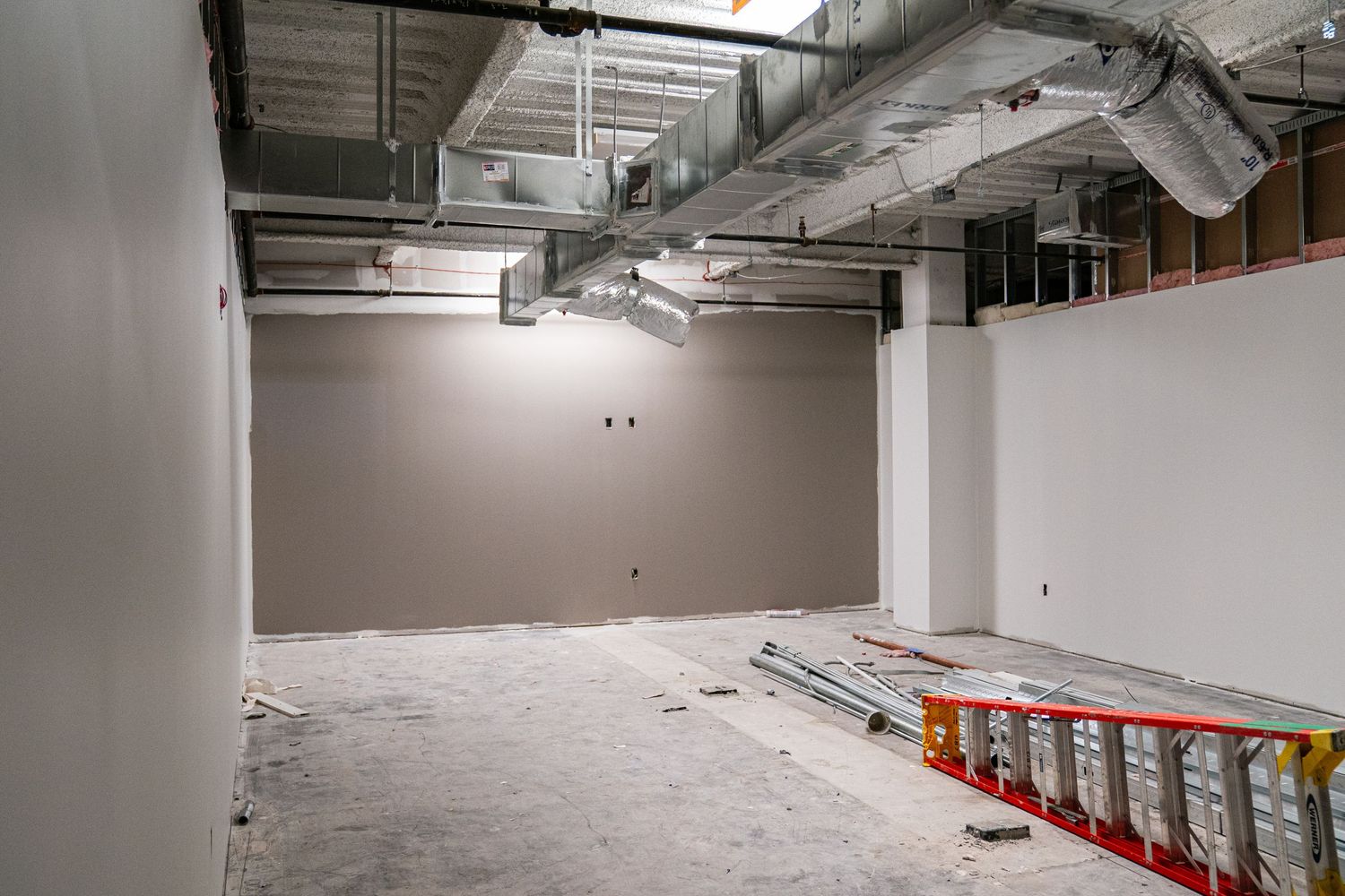Commercial building interior during renovation showing exposed mechanical systems.