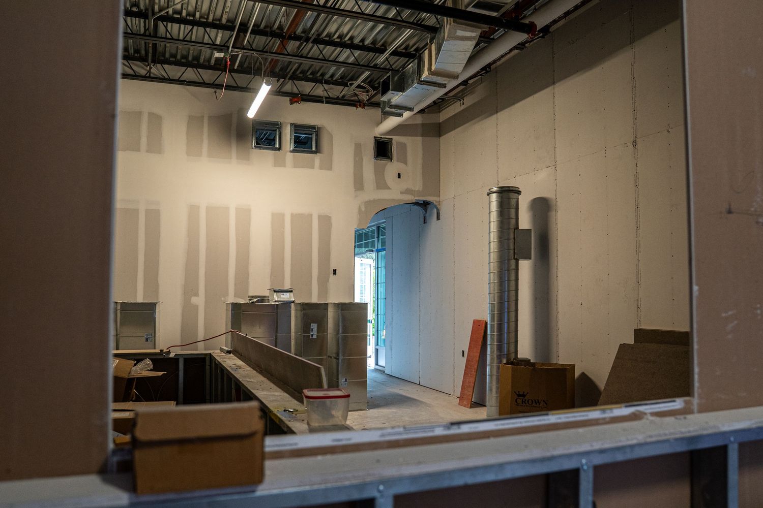 Commercial building interior during construction phase showing drywall installation.