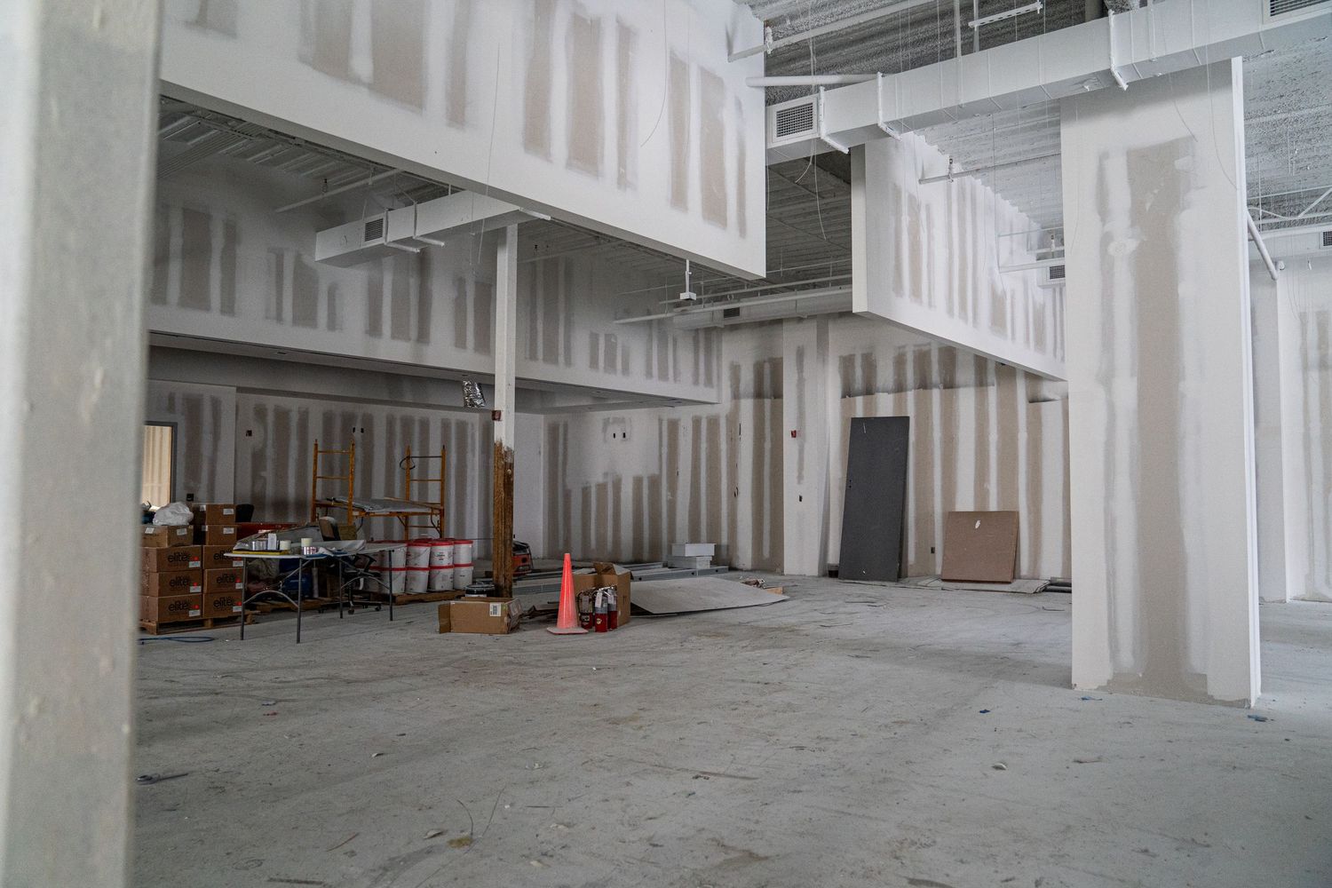 Interior of commercial building under renovation showing open layout and support columns.