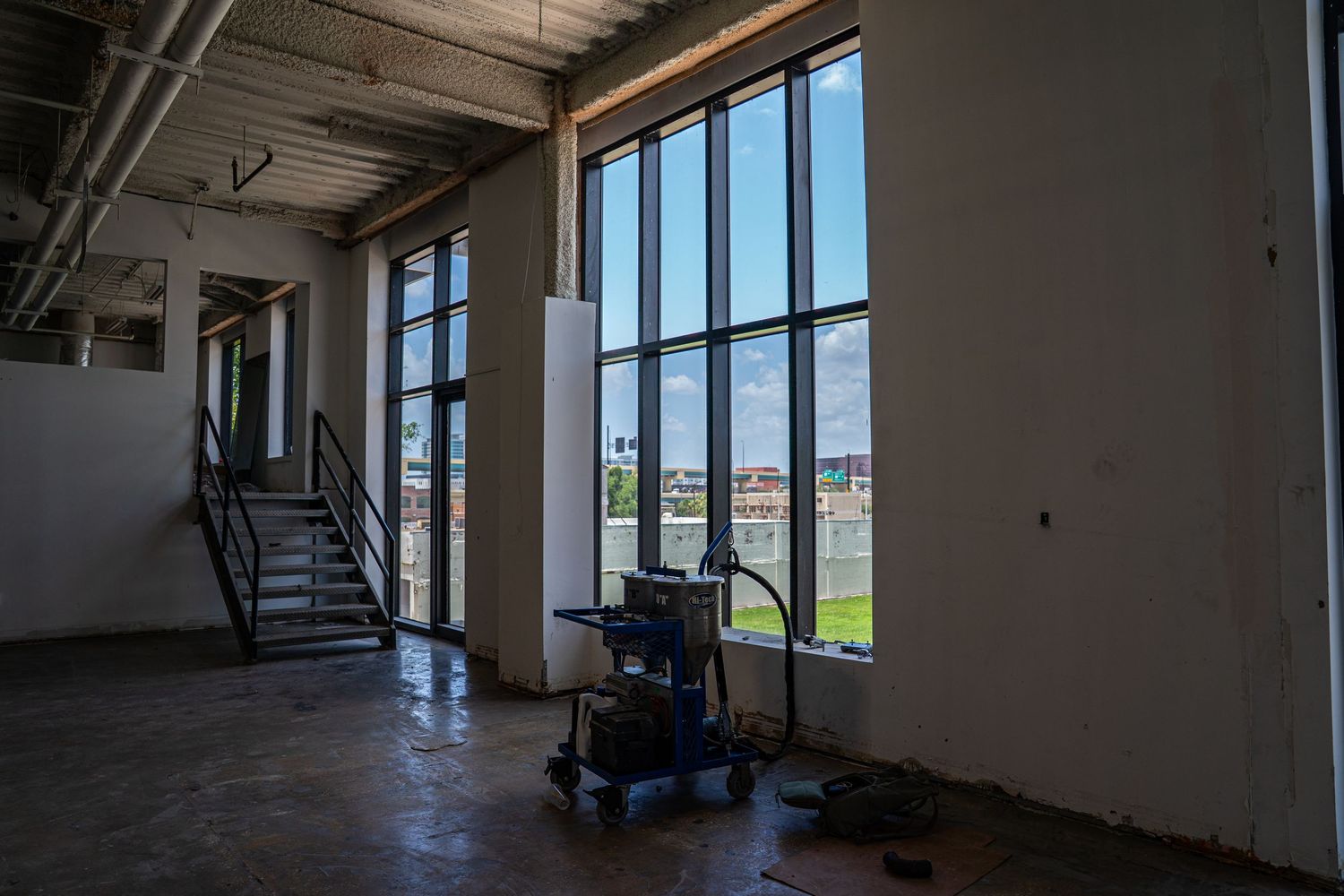 Bright commercial space with industrial elements and panoramic window views.